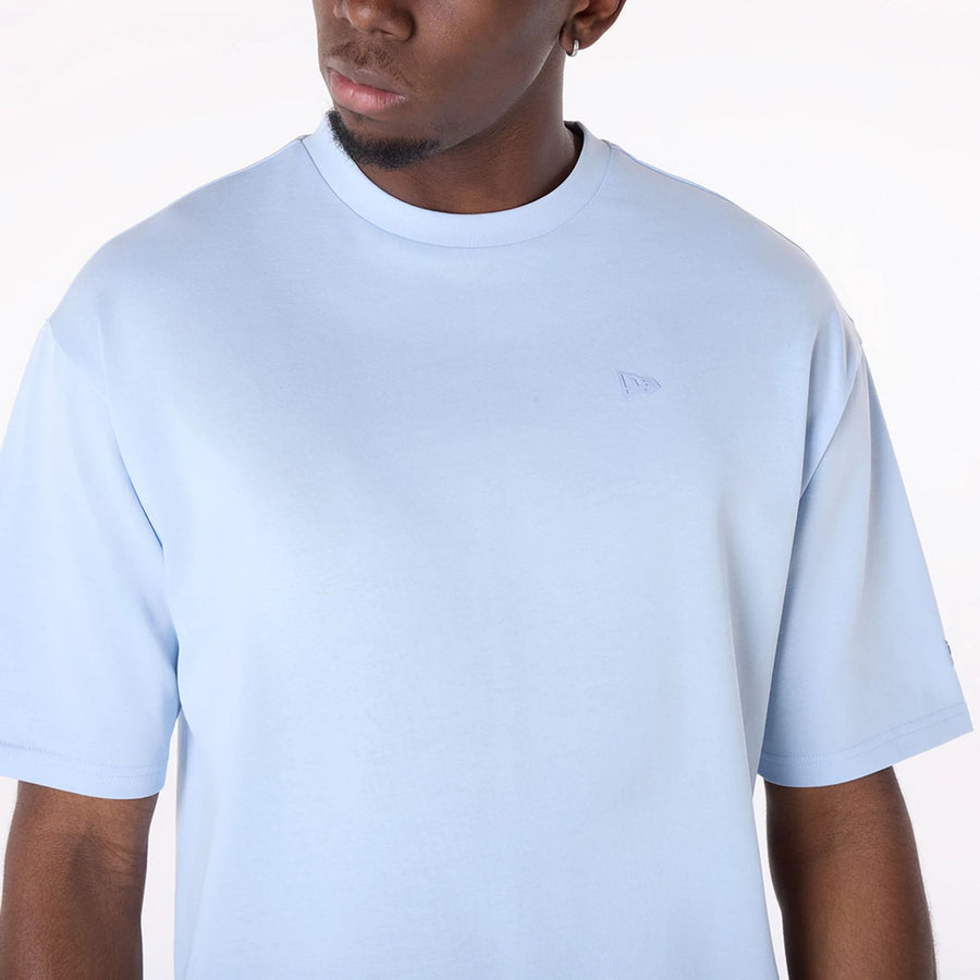 The Male model is wearing New Era Sticker Pastel Blue Oversized T-Shirt 3