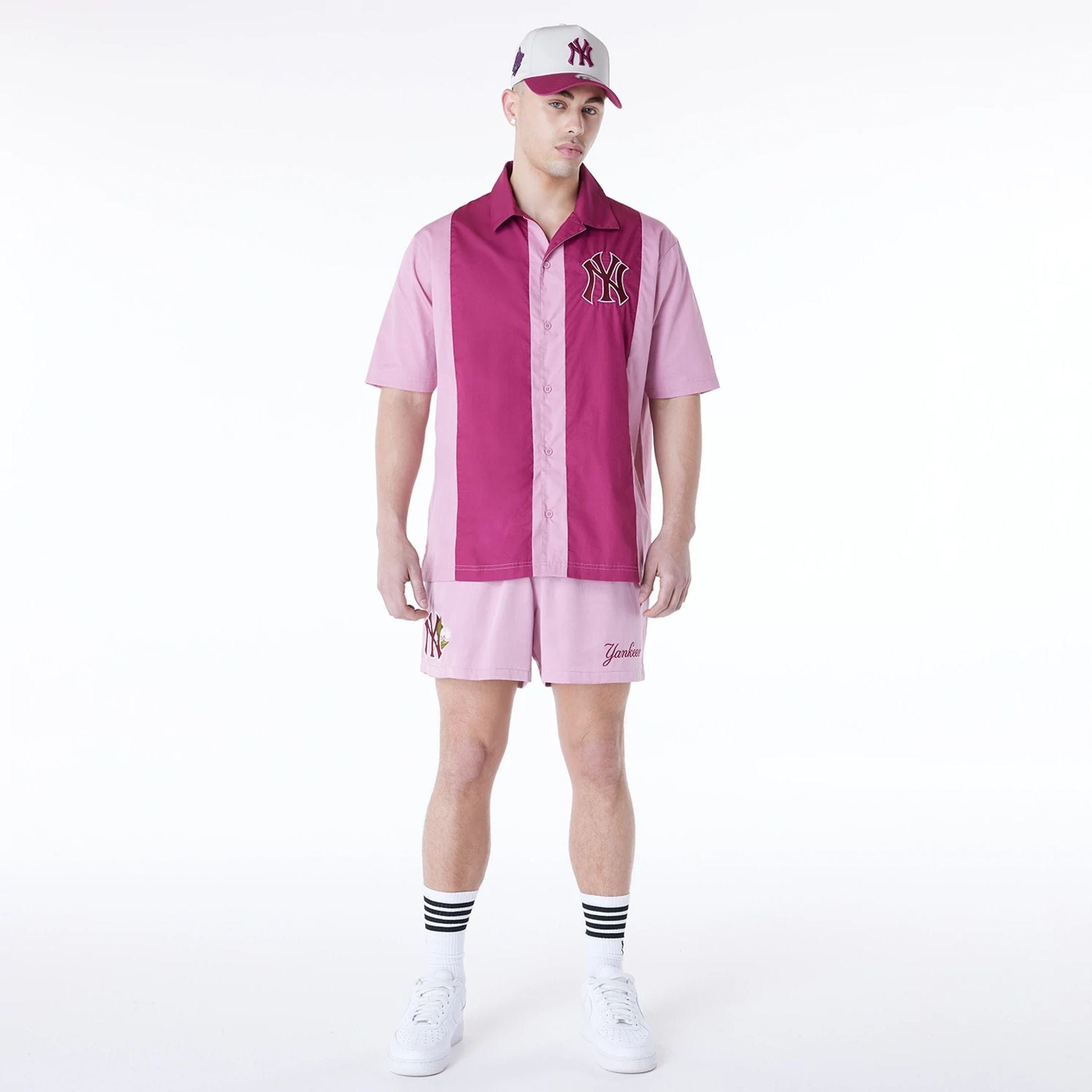 The Male model is wearing New York Yankees MLB Woven Dark Pink Shorts 5
