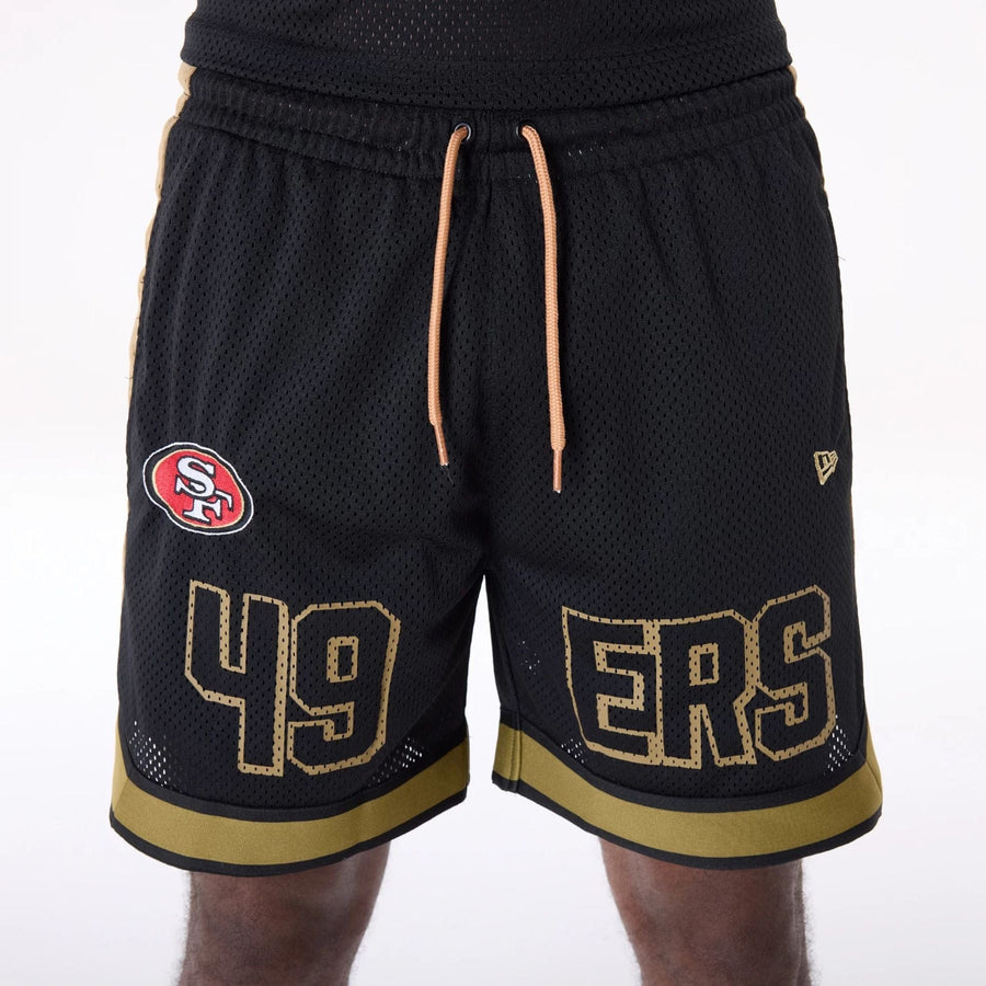 The Male model is wearing San Francisco 49ers NFL Mesh Black Shorts 4
