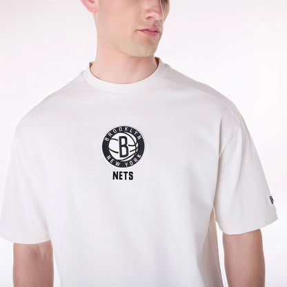 The Male model is wearing Brooklyn Nets NBA Wordmark Open White Oversized T-Shirt 7