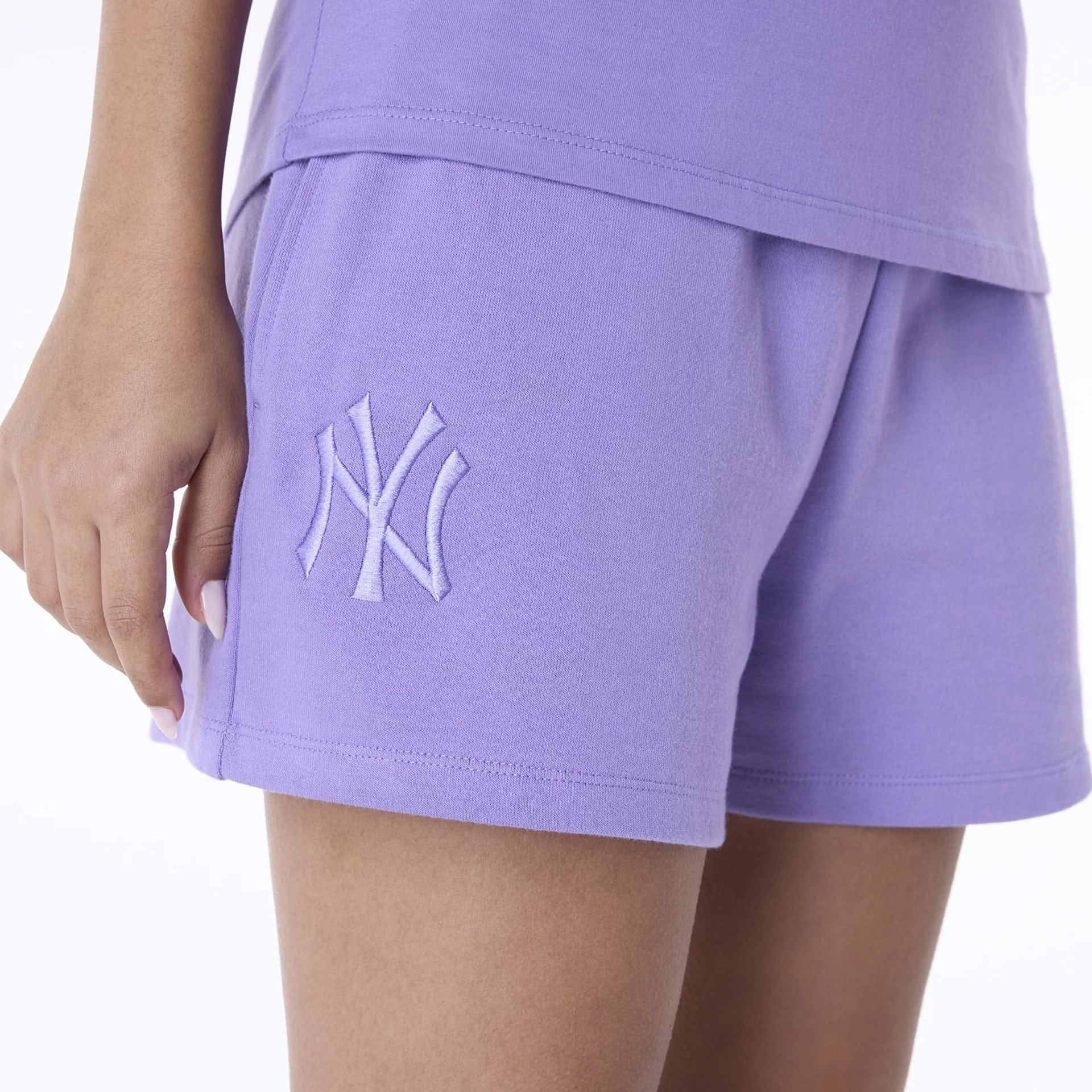 The Female model is wearing New York Yankees Womens MLB League Essential Purple Shorts 3