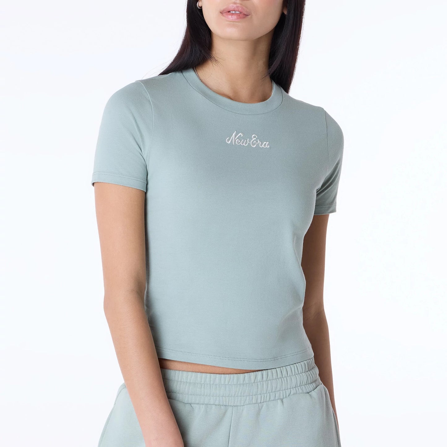 The Female model is wearing Womens New Era Slim Pastel Blue T-Shirt 5