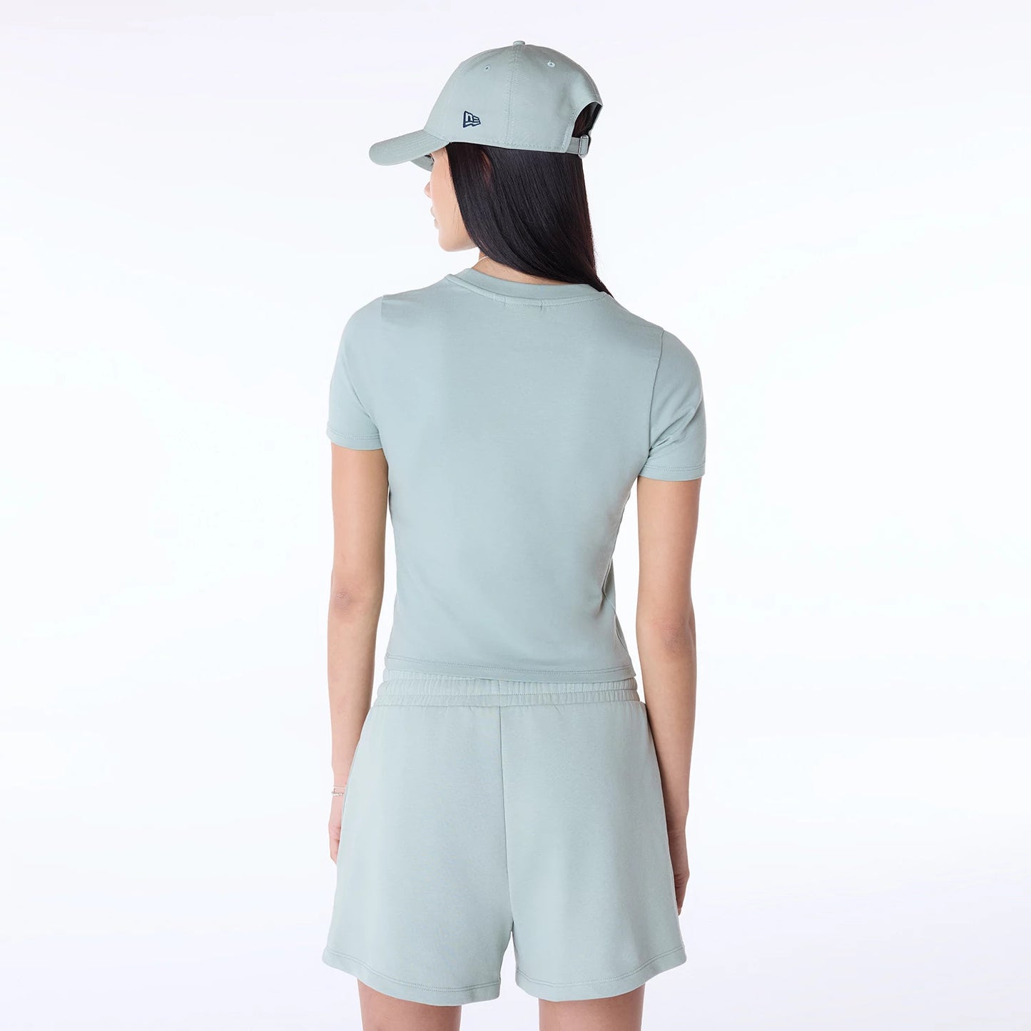 The Female model is wearing Womens New Era Slim Pastel Blue T-Shirt 7
