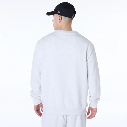 The Male model is wearing New Era Essential Pastel Grey Crew Neck Sweater 2