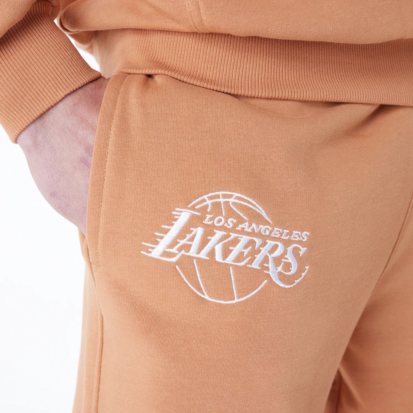 The Male model is wearing LA Lakers NBA League Essential Dark Beige Fleece Joggers 5