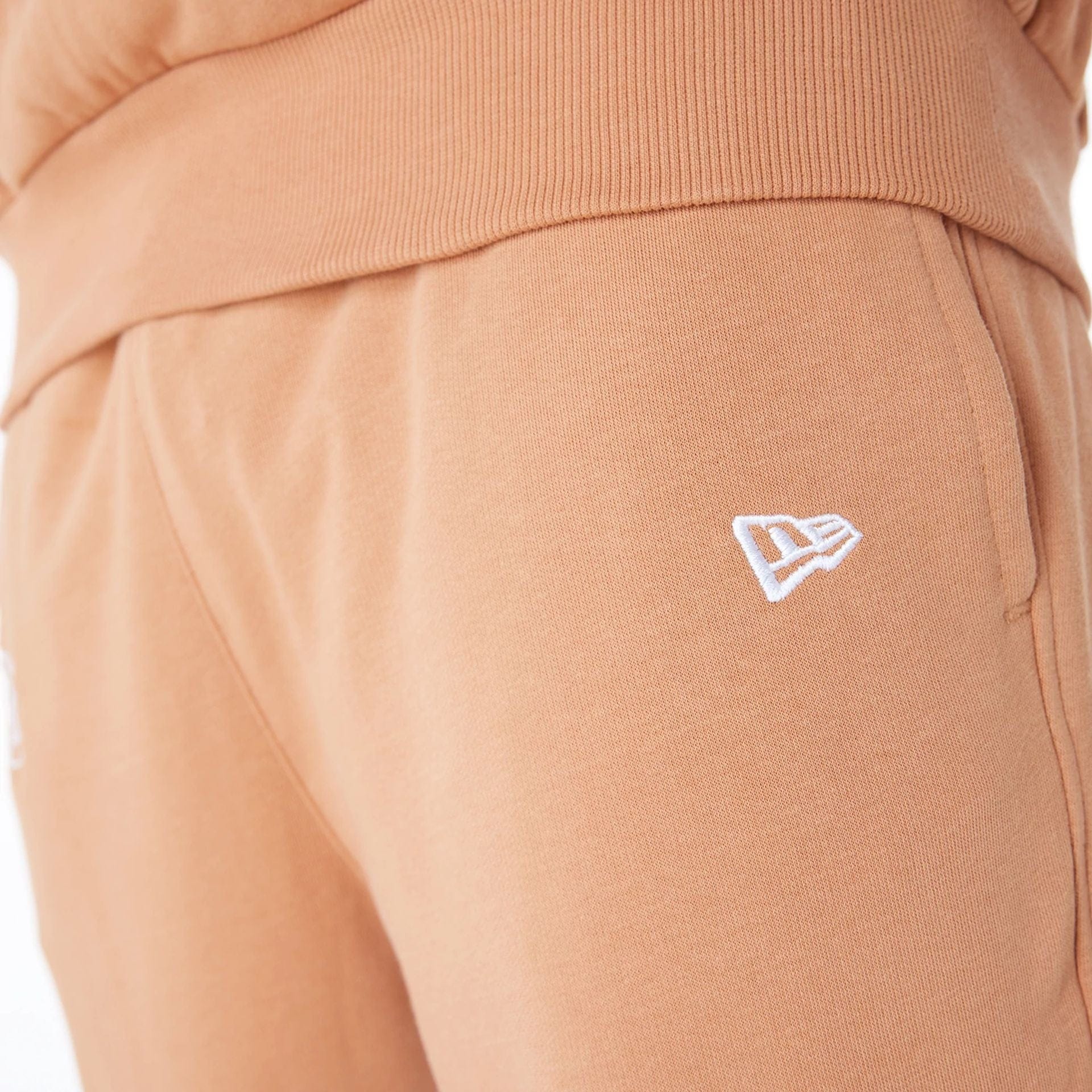 The Male model is wearing LA Lakers NBA League Essential Dark Beige Fleece Joggers 6