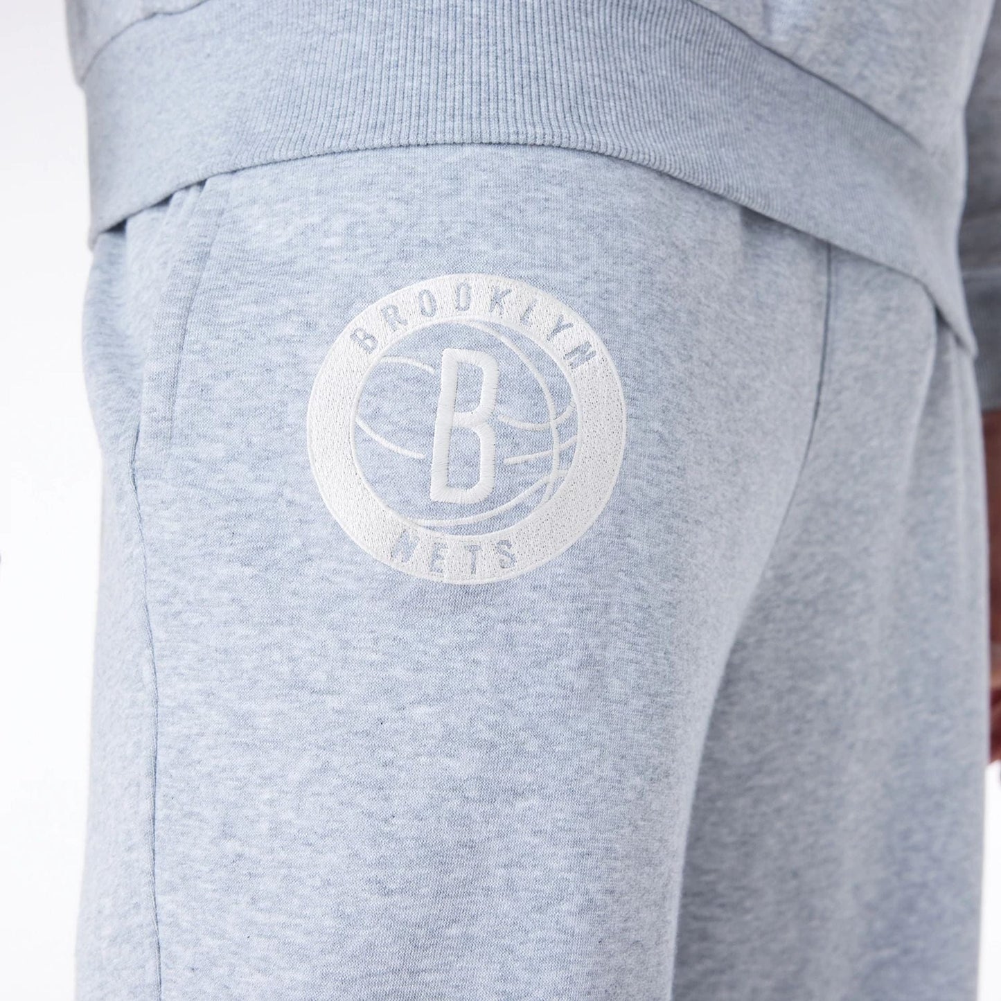 The Male model is wearing Brooklyn Nets NBA League Essential Grey Fleece Joggers 5