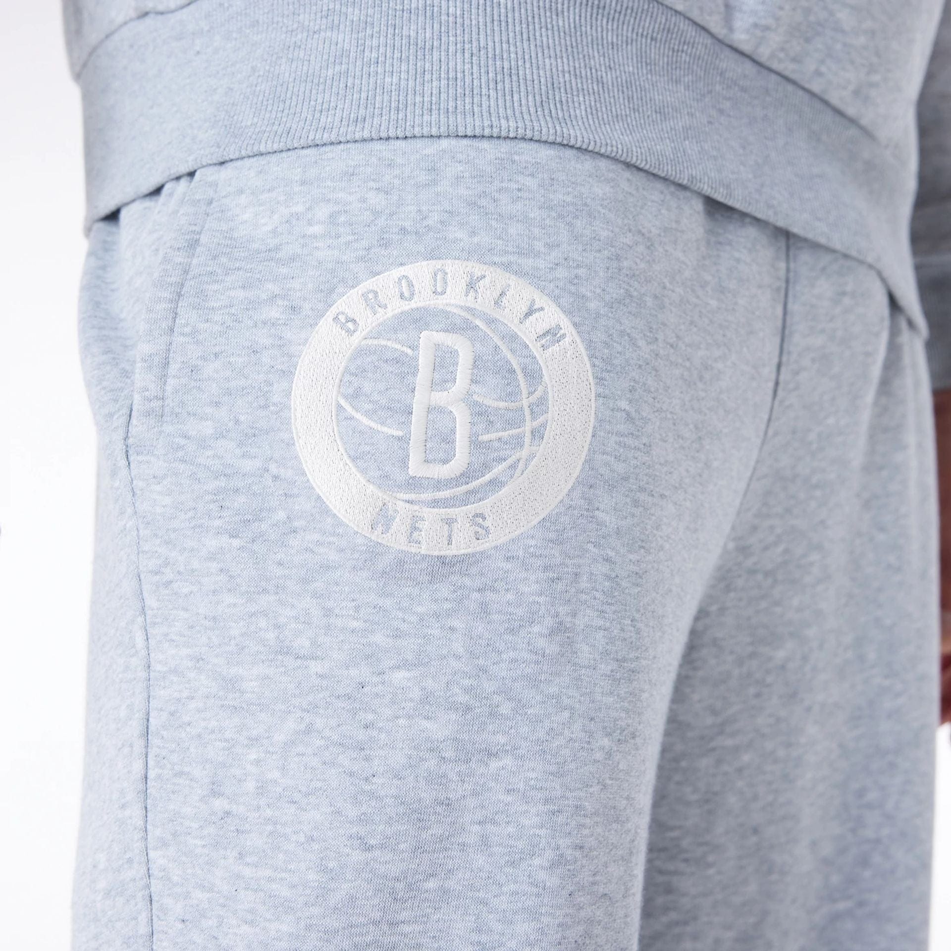 The Male model is wearing Brooklyn Nets NBA League Essential Grey Fleece Joggers 5