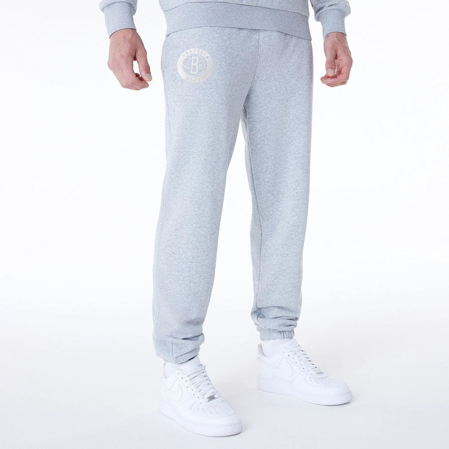 The Male model is wearing Brooklyn Nets NBA League Essential Grey Fleece Joggers 1