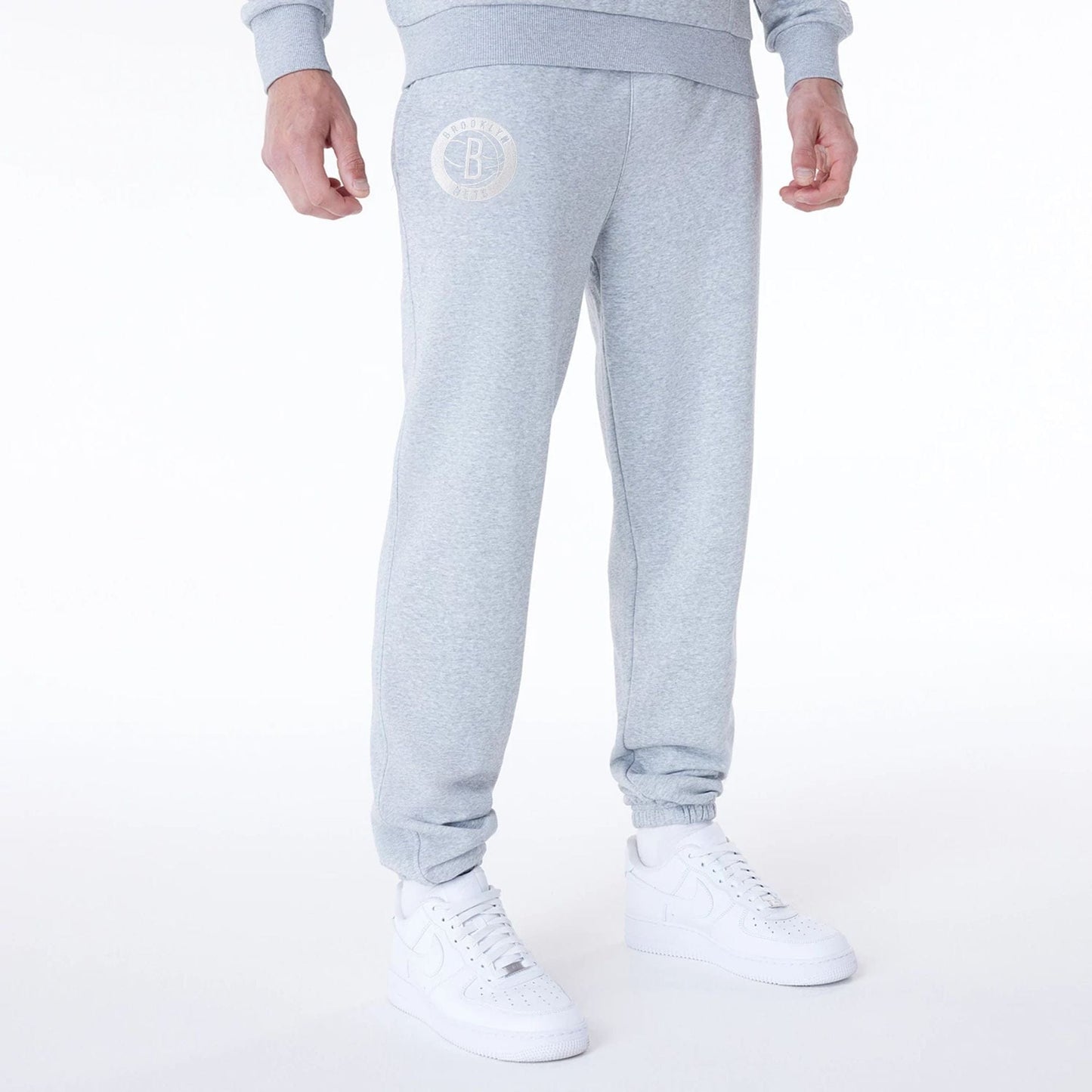 The Male model is wearing Brooklyn Nets NBA League Essential Grey Fleece Joggers 1