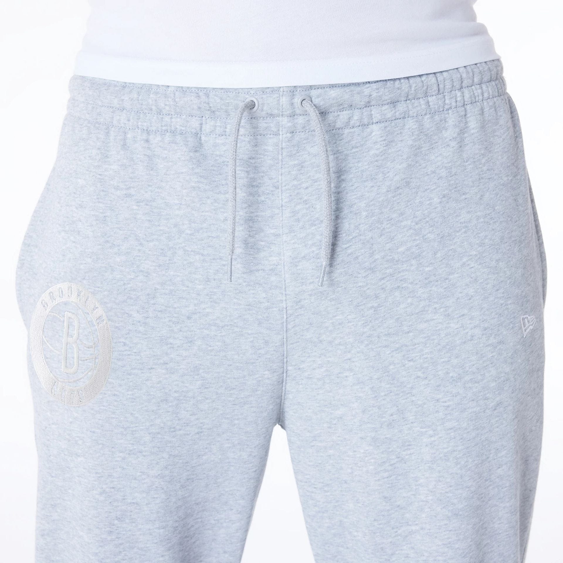 The Male model is wearing Brooklyn Nets NBA League Essential Grey Fleece Joggers 4