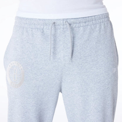 The Male model is wearing Brooklyn Nets NBA League Essential Grey Fleece Joggers 4