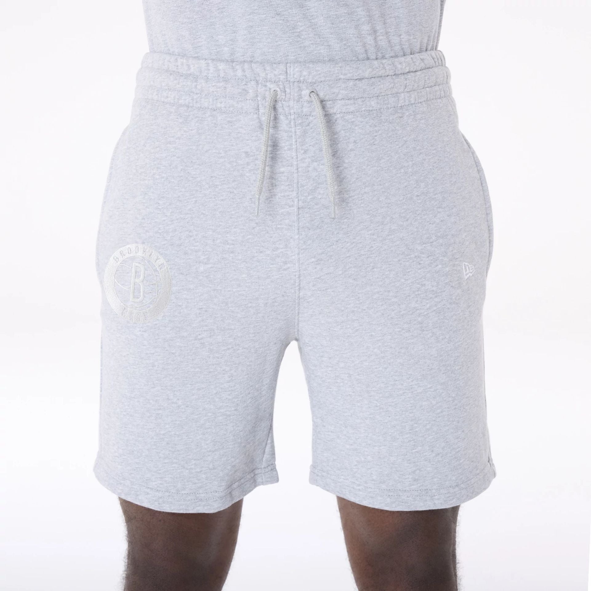 The Male model is wearing Brooklyn Nets NBA League Essential Grey Shorts 5