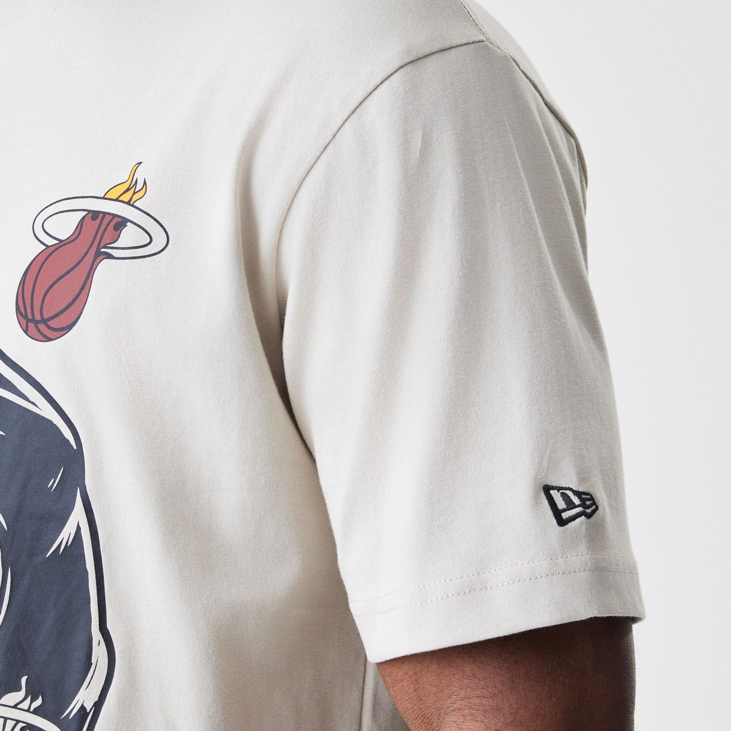 The Male model is wearing Miami Heat Modern Driver Light Beige T-Shirt 4