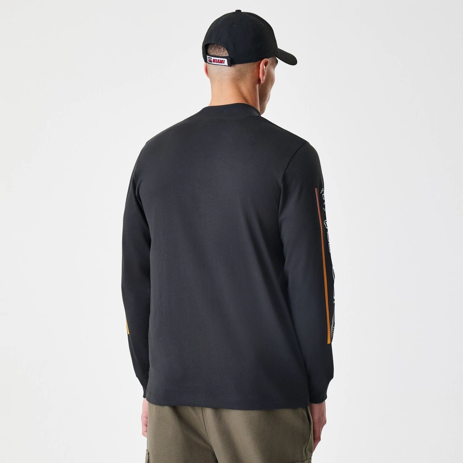 The Male model is wearing Miami Heat Modern Driver Black Long Sleeve T-Shirt 3