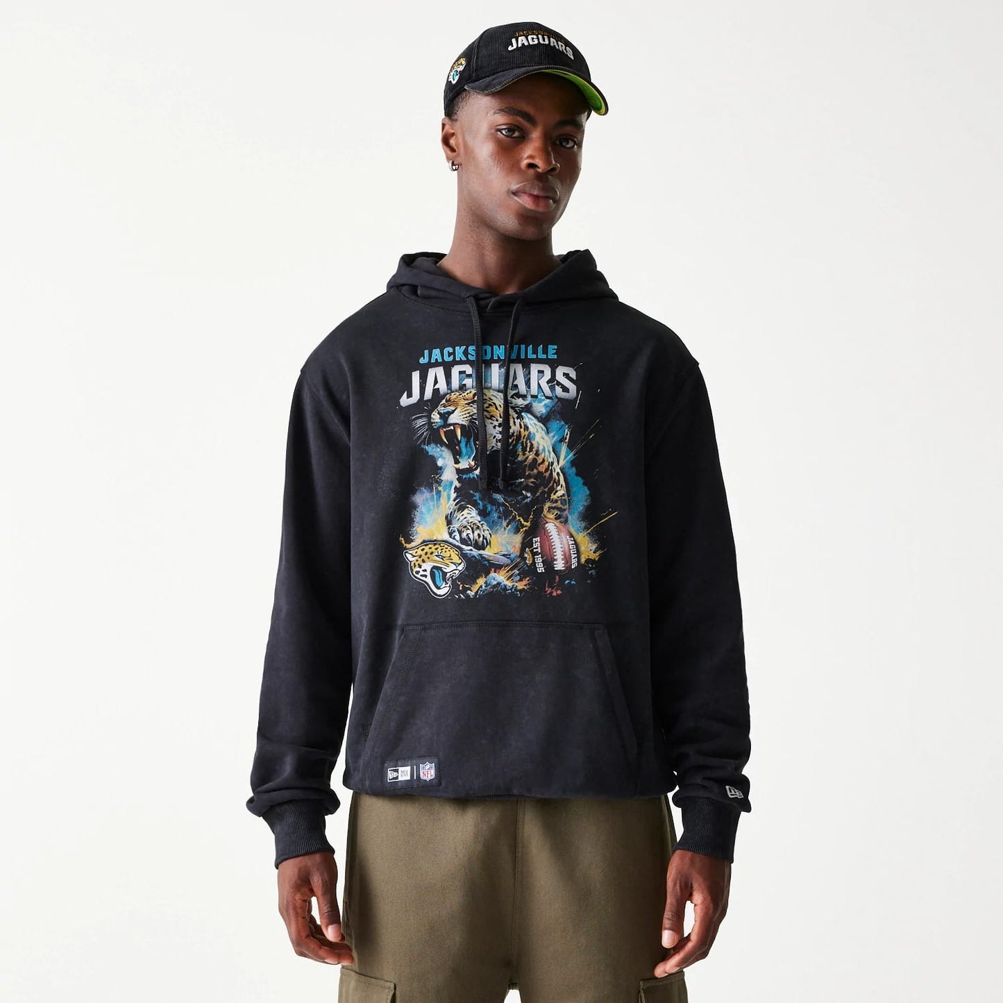 The Male model is wearing Jacksonville Jaguars NFL Games Premium Apparel Black Oversized Pullover Hoodie 1