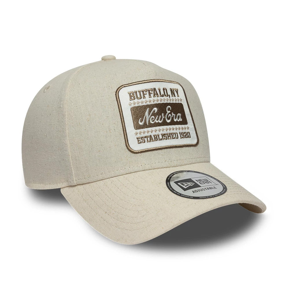 New Era Patch Line Cream New Era 9FORTY E-Frame Adjustable Cap, front view showing a brown and cream embroidered patch logo on the front panel and a 9FORTY size sticker on the cream curved visor.