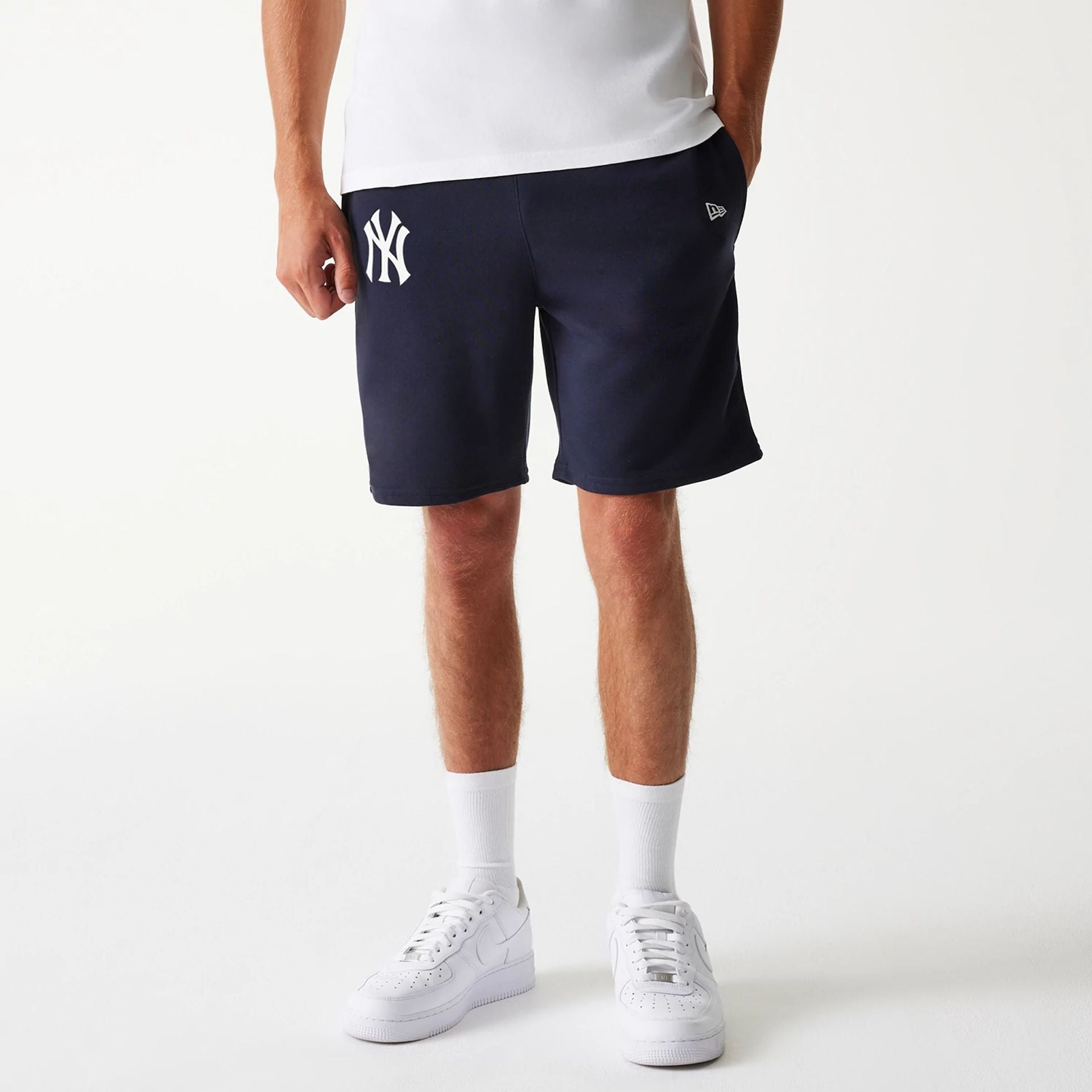The Male model is wearing New York Yankees MLB League Essential Navy Shorts 1