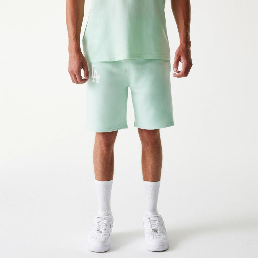 The Male model is wearing LA Dodgers MLB League Essential Pastel Green Shorts 1