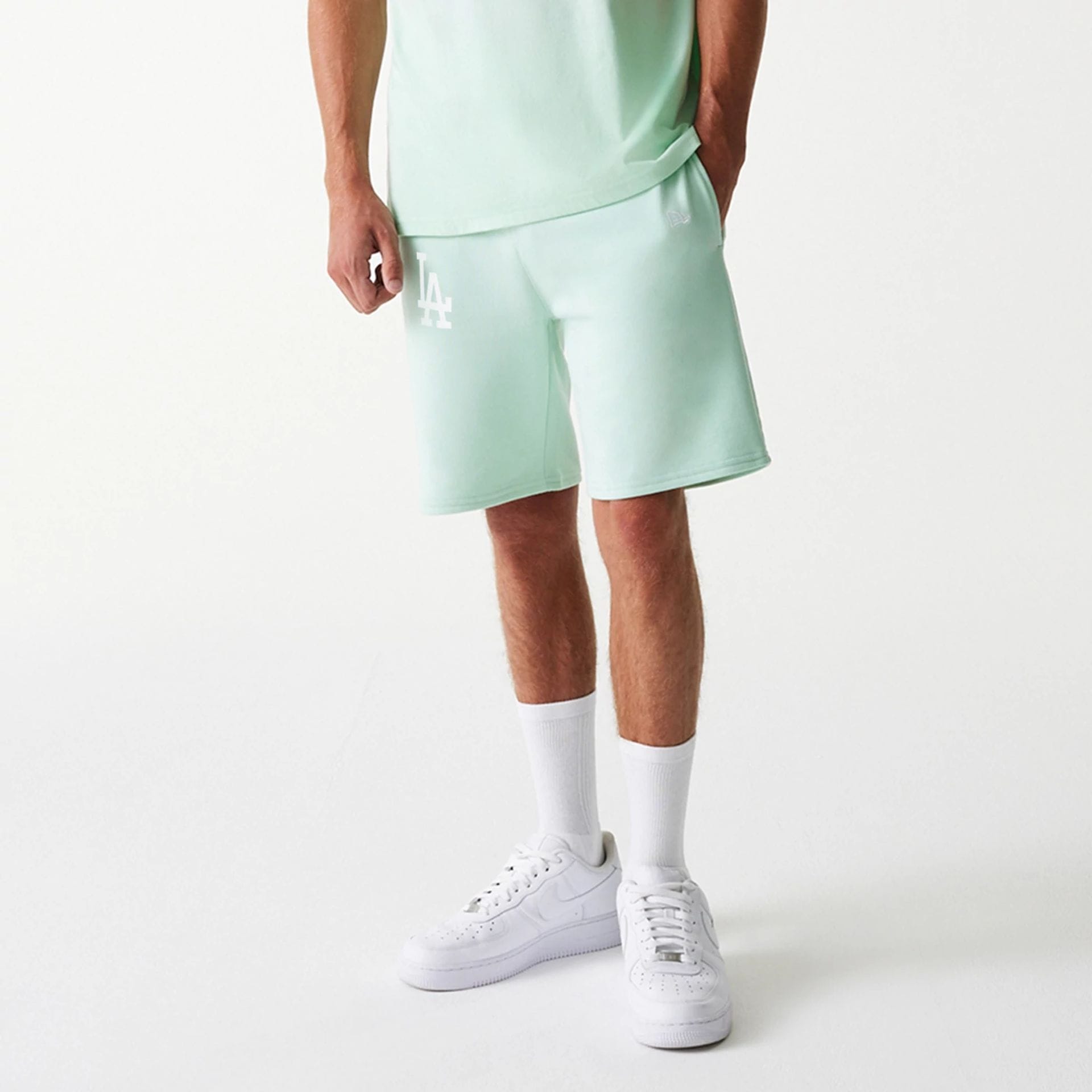 The Male model is wearing LA Dodgers MLB League Essential Pastel Green Shorts 3