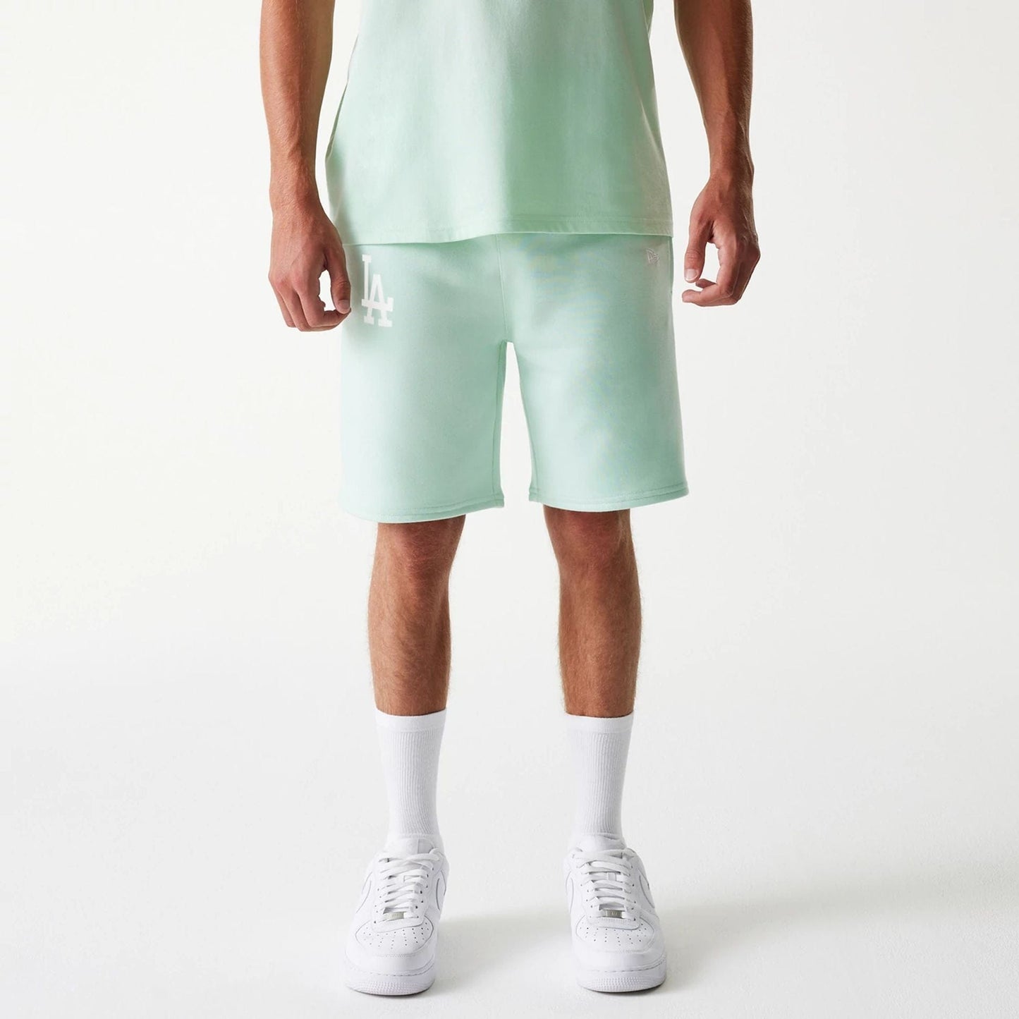 The Male model is wearing LA Dodgers MLB League Essential Pastel Green Shorts 1
