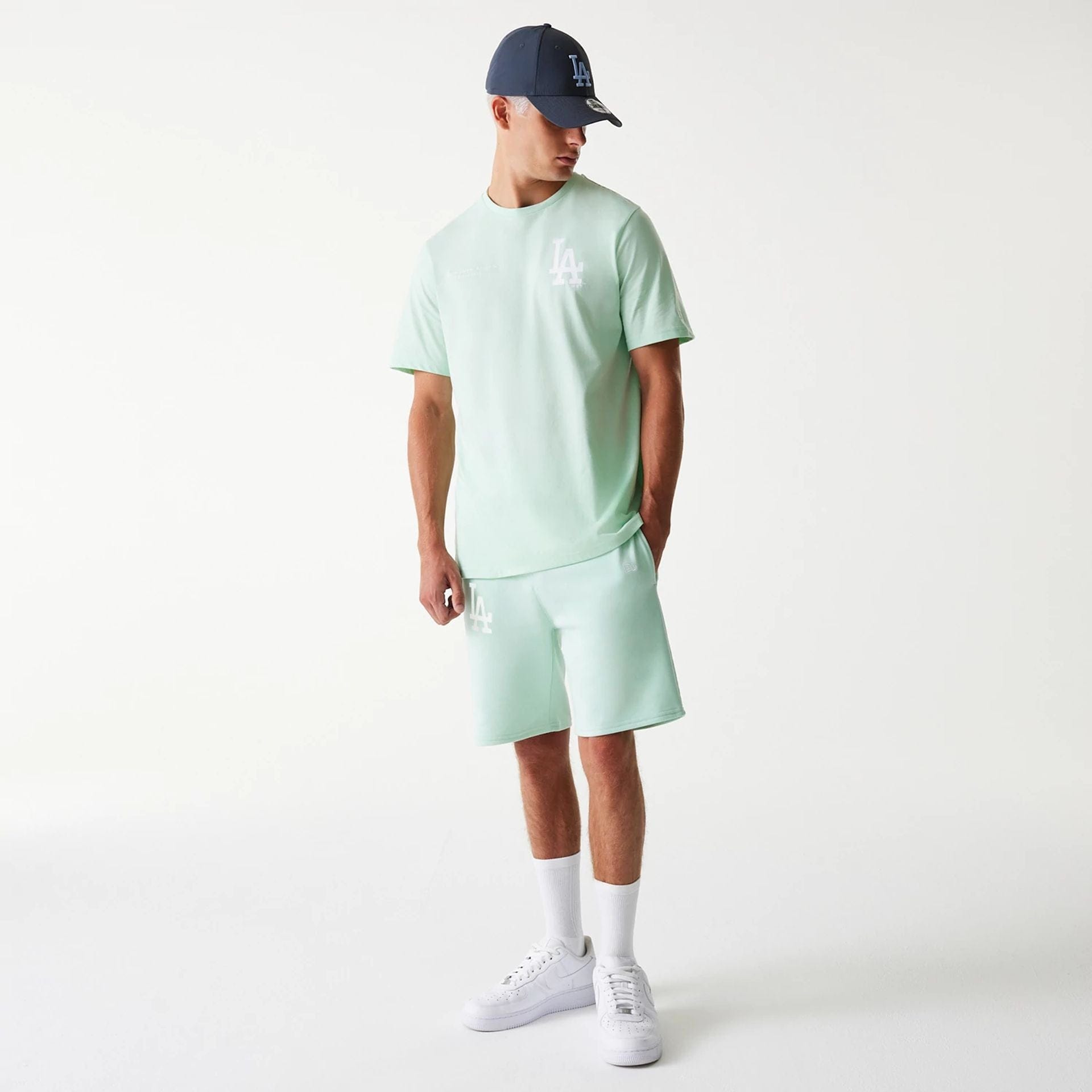 The Male model is wearing LA Dodgers MLB League Essential Pastel Green Shorts 8