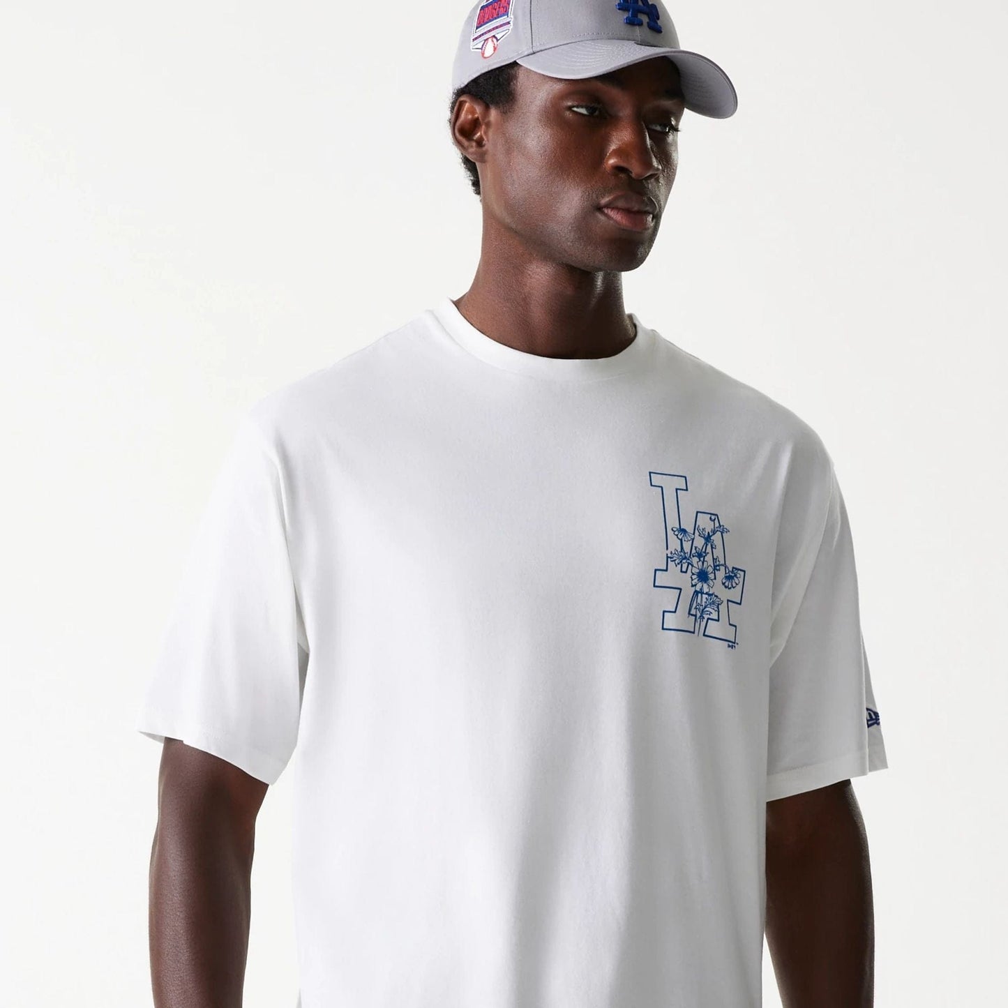 The Male model is wearing LA Dodgers MLB Floral Graphic White Oversized T-Shirt 5