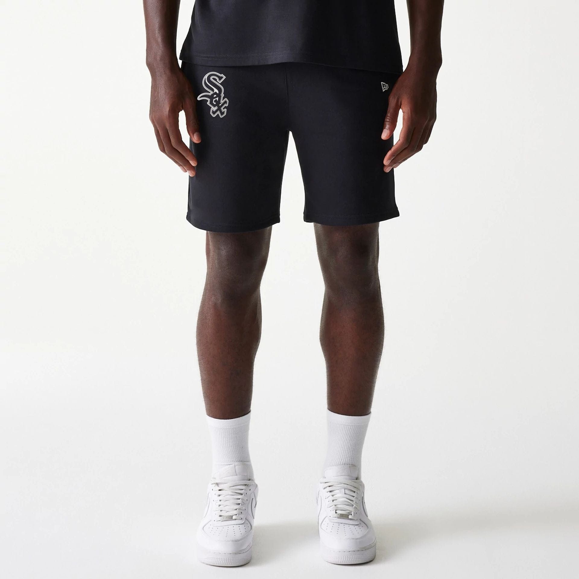 The Male model is wearing Chicago White Sox MLB League Essential Black Shorts 1