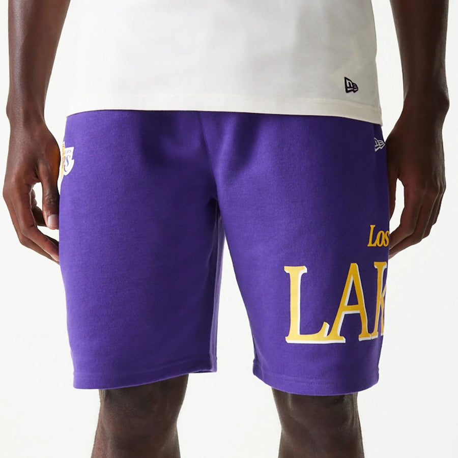 The Male model is wearing LA Lakers NBA Team Graphic Purple Shorts 3