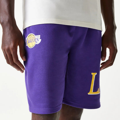 The Male model is wearing LA Lakers NBA Team Graphic Purple Shorts 6