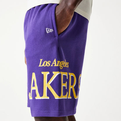 The Male model is wearing LA Lakers NBA Team Graphic Purple Shorts 5