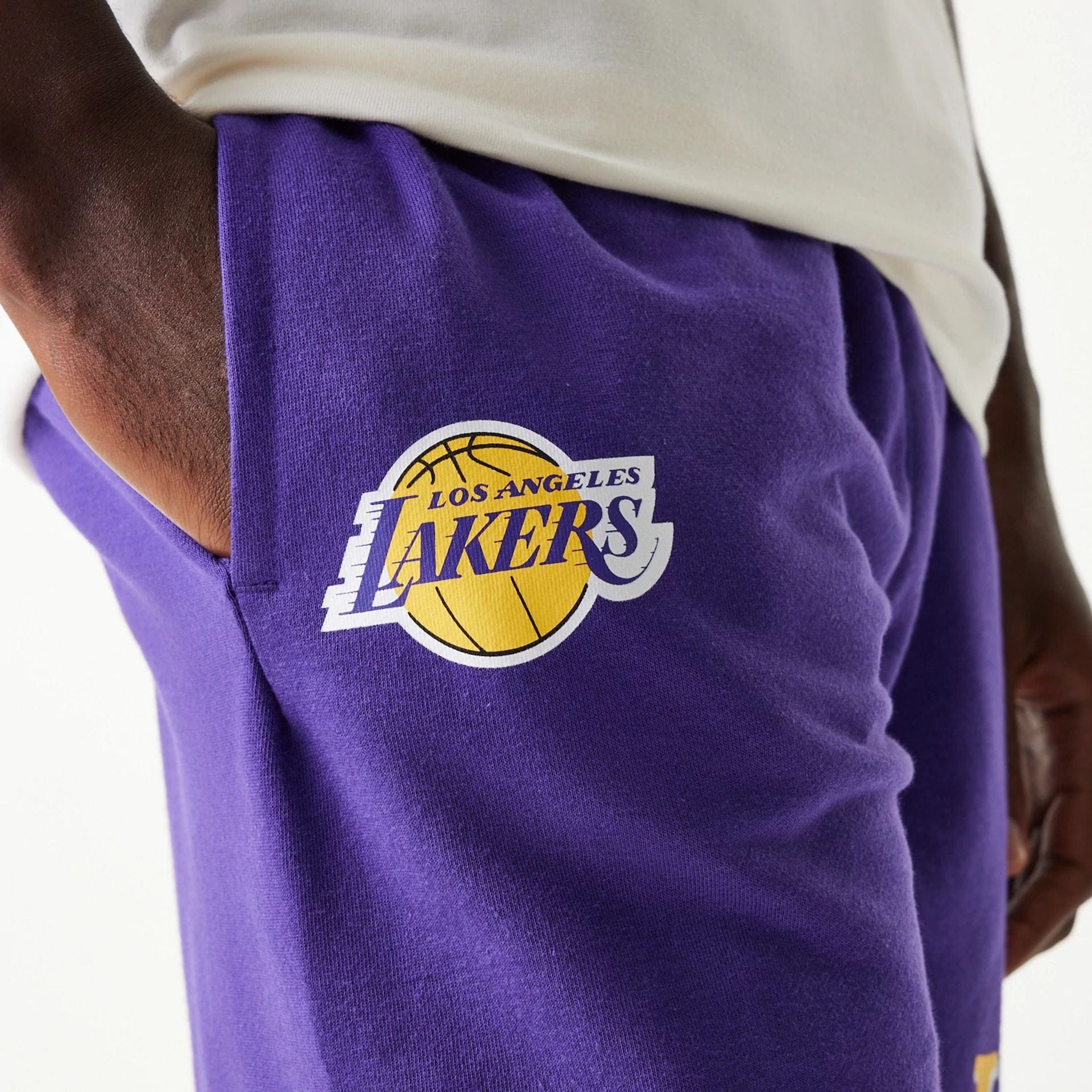The Male model is wearing LA Lakers NBA Team Graphic Purple Shorts 4