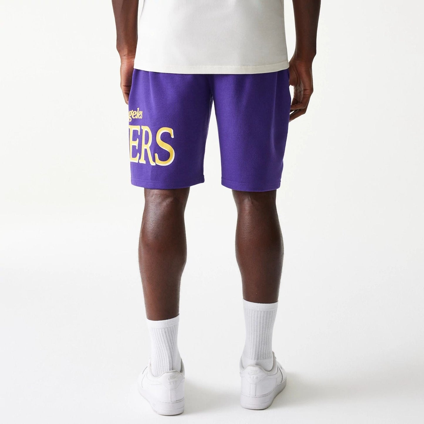 The Male model is wearing LA Lakers NBA Team Graphic Purple Shorts 2
