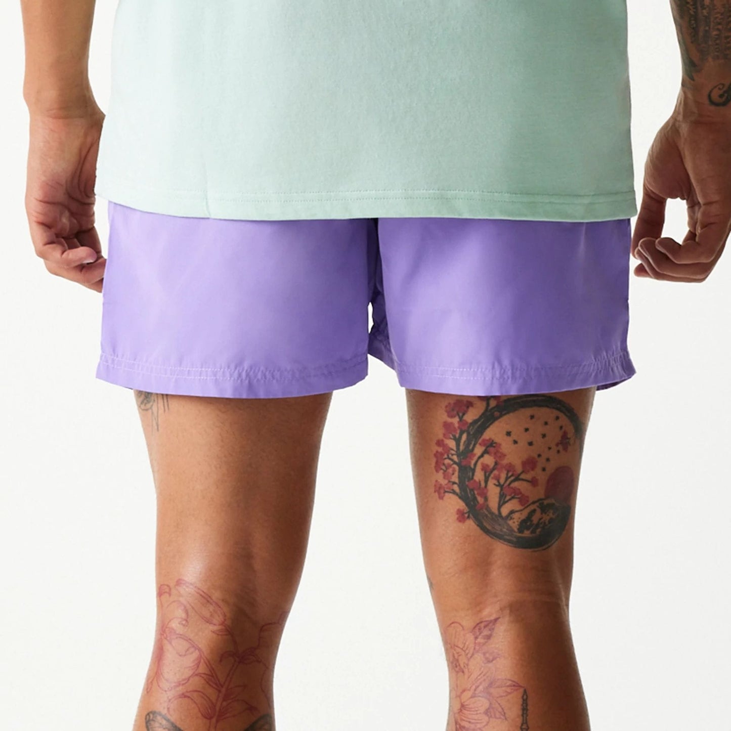 The Male model is wearing New Era Purple Swim Shorts 6