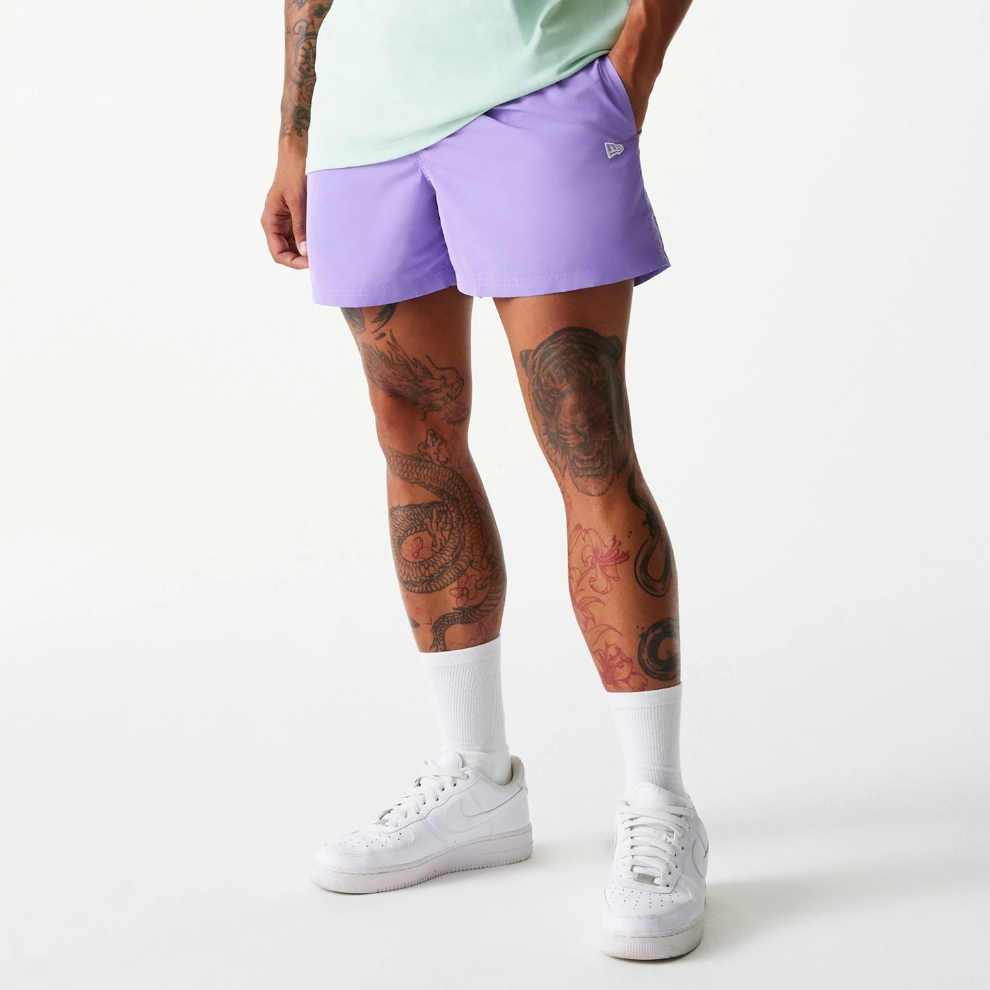 The Male model is wearing New Era Purple Swim Shorts 1