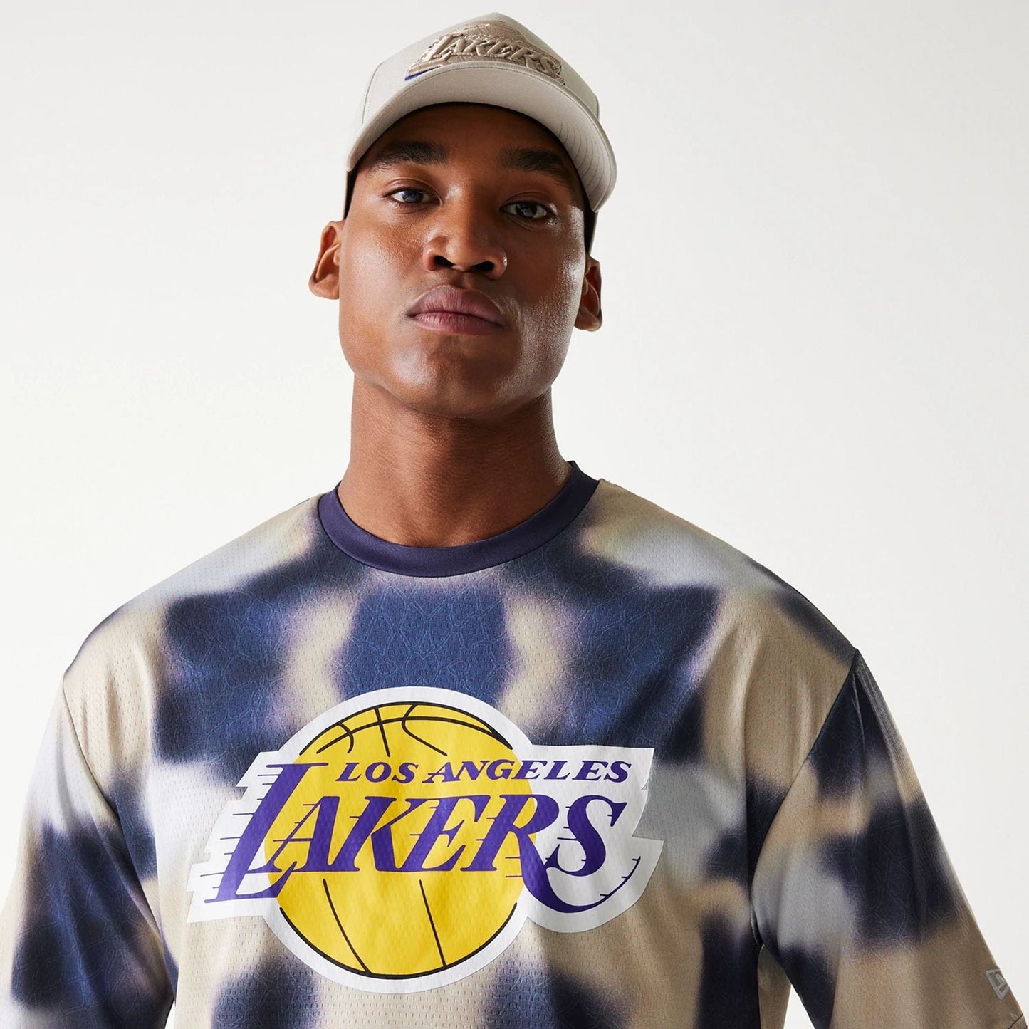 The Male model is wearing LA Lakers NBA All Over Print Cream Oversized T-Shirt 4