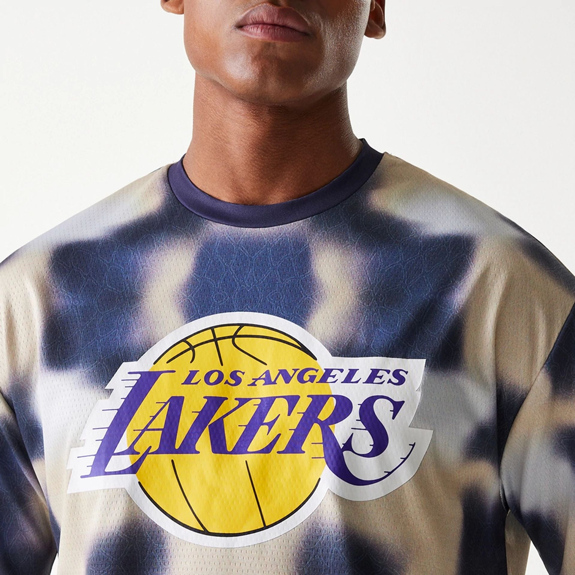 The Male model is wearing LA Lakers NBA All Over Print Cream Oversized T-Shirt 6