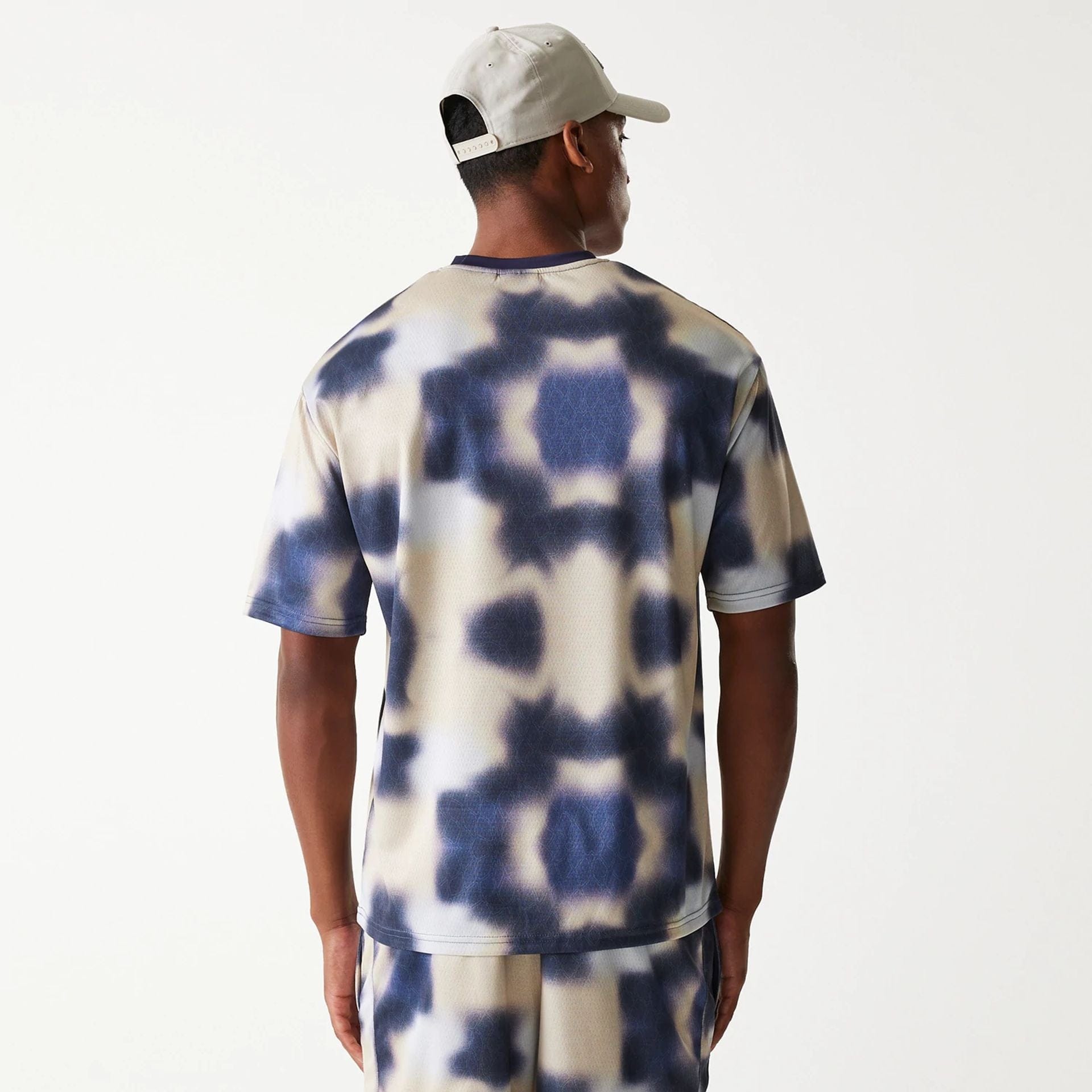 The Male model is wearing LA Lakers NBA All Over Print Cream Oversized T-Shirt 2