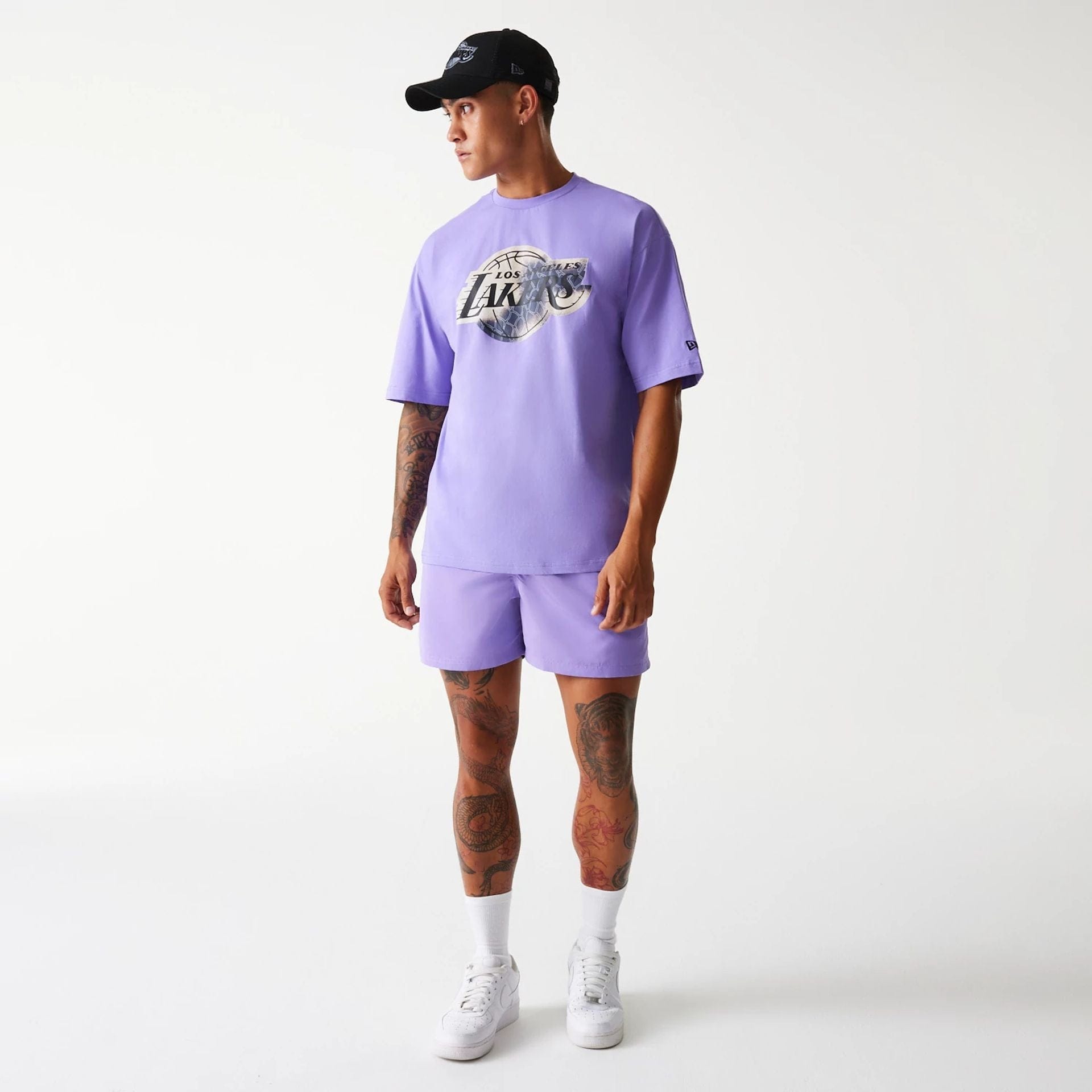 The Male model is wearing LA Lakers NBA All Over Print Infill Purple Oversized T-Shirt 8