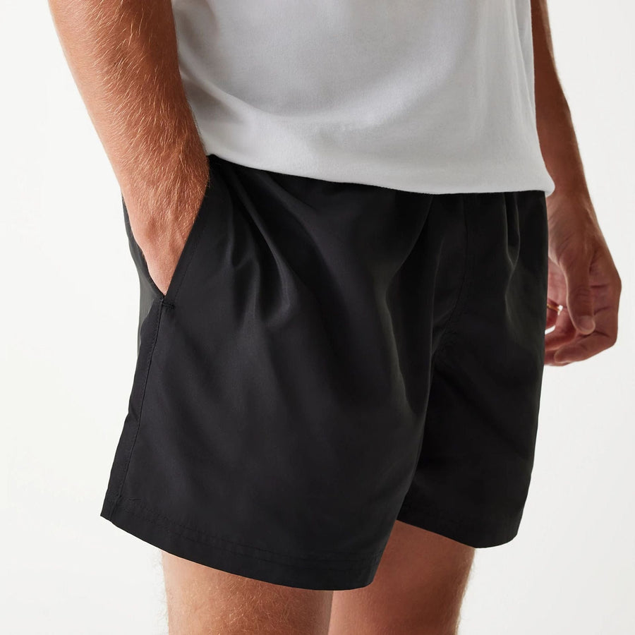 The Male model is wearing New Era Black Swim Shorts 4