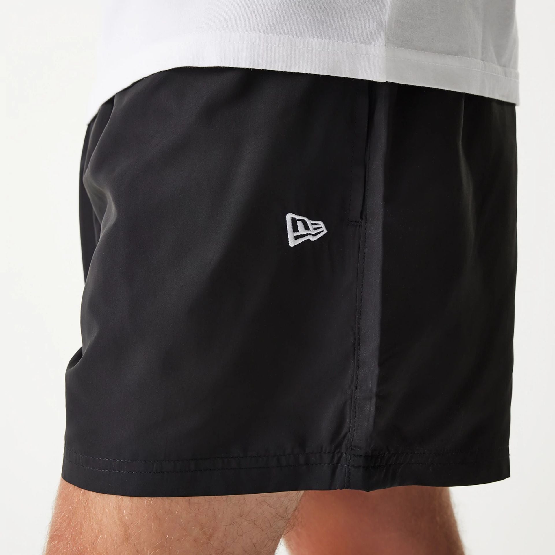 The Male model is wearing New Era Black Swim Shorts 5