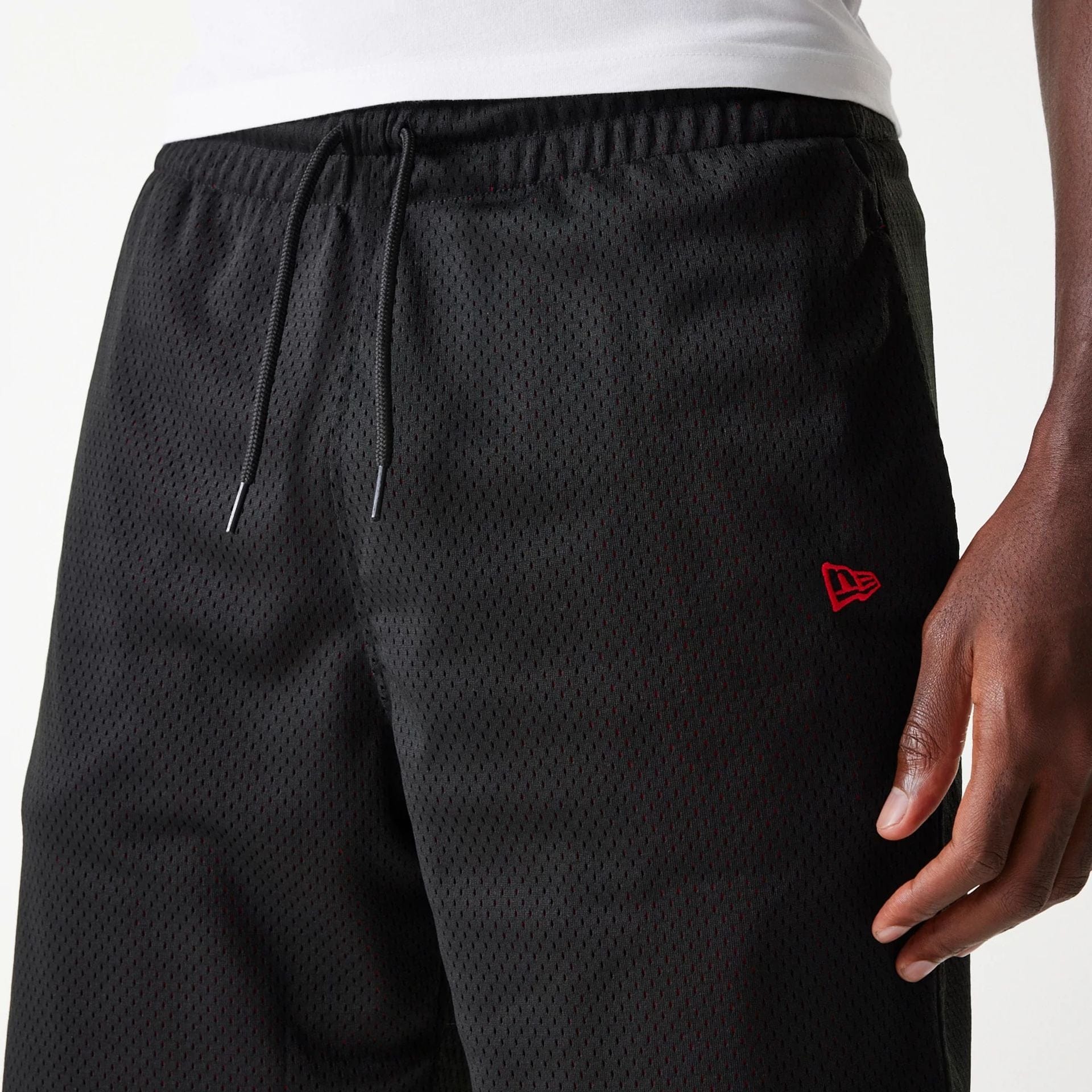 The Male model is wearing New Era Black Mesh Shorts 5