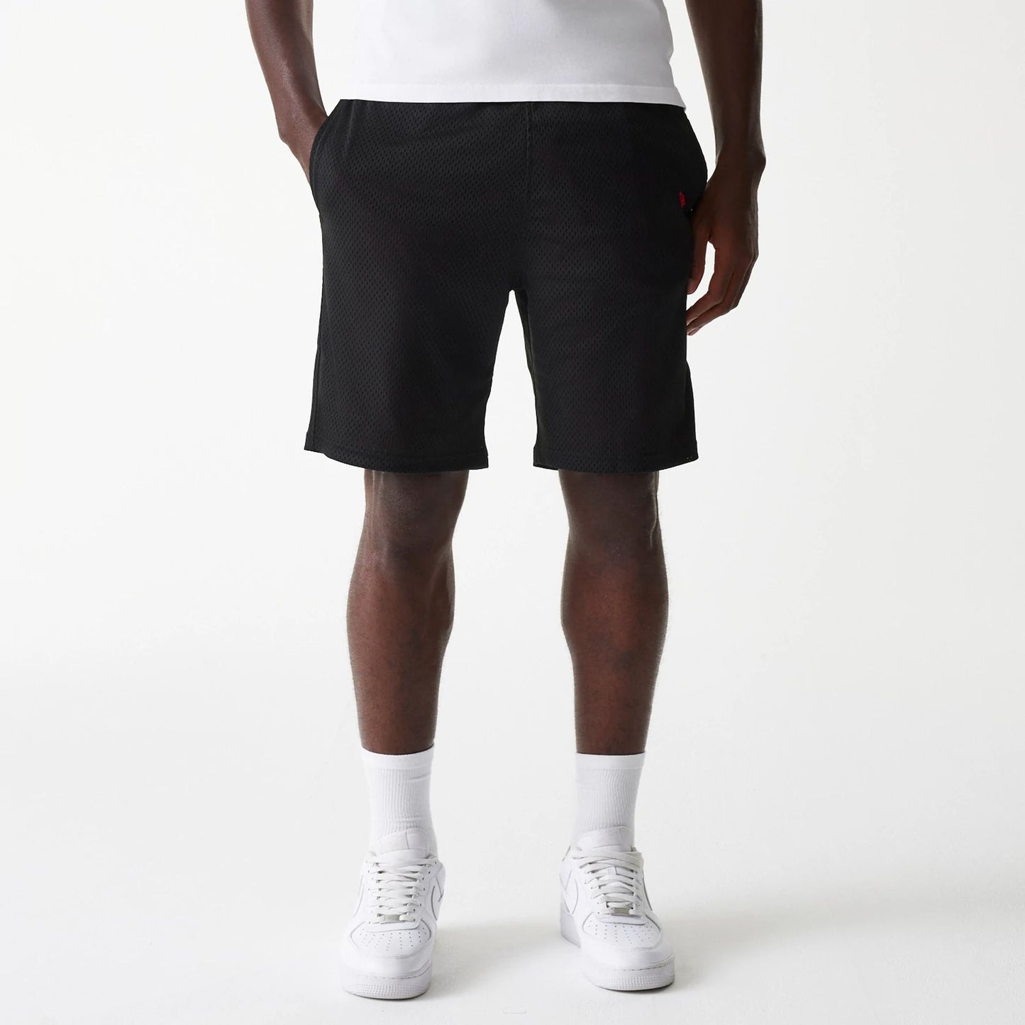 The Male model is wearing New Era Black Mesh Shorts 1