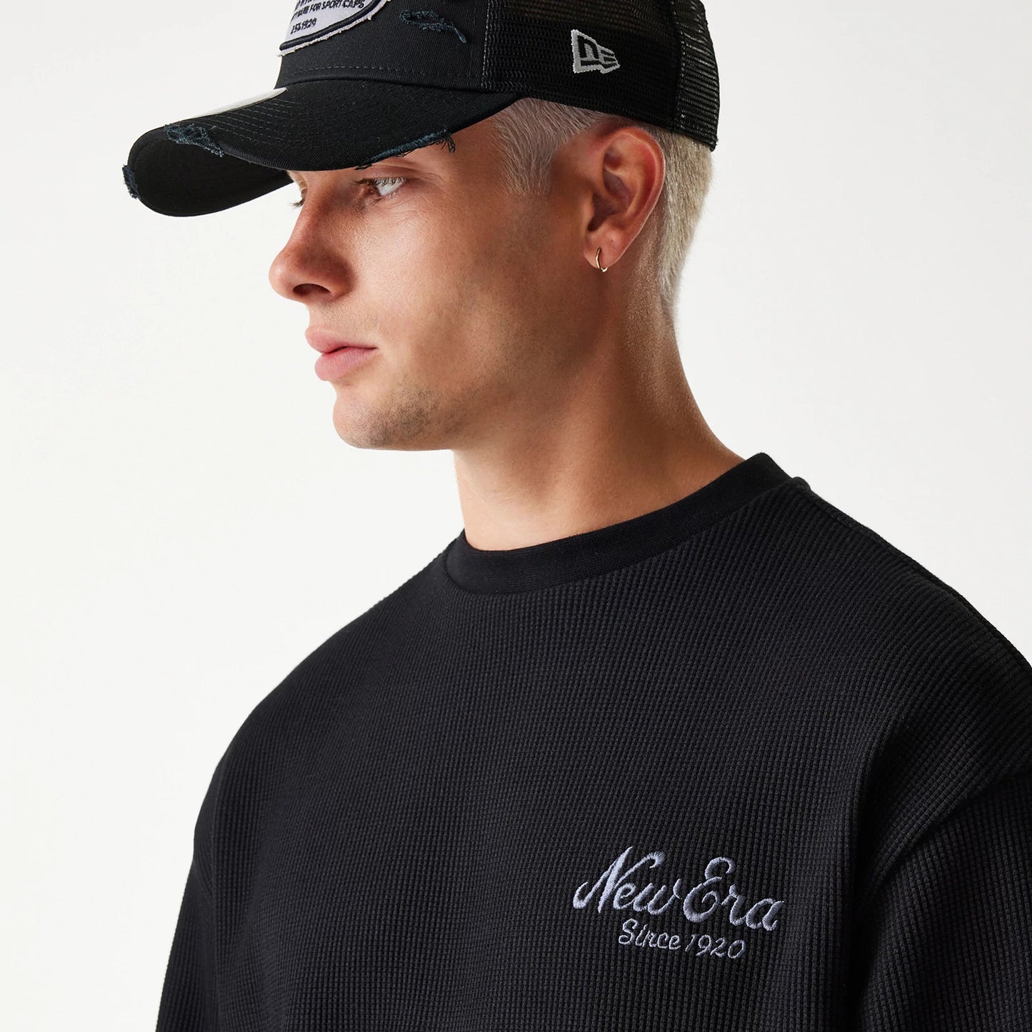 The Male model is wearing New Era Waffle Black Oversized Crew Neck Sweater 4