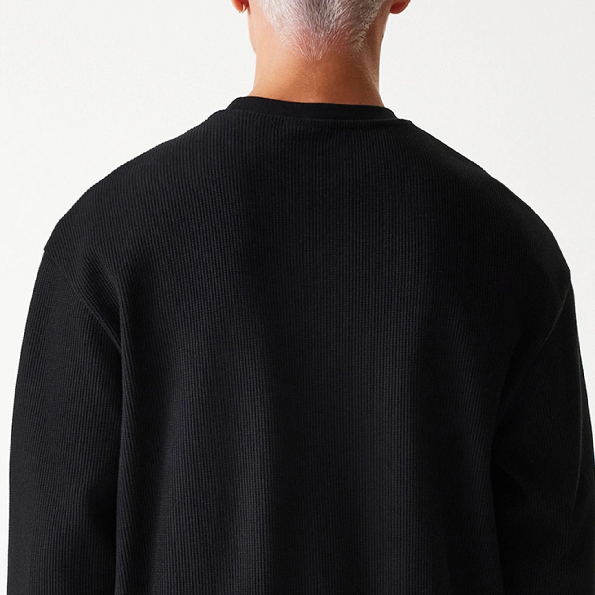 The Male model is wearing New Era Waffle Black Oversized Crew Neck Sweater 6