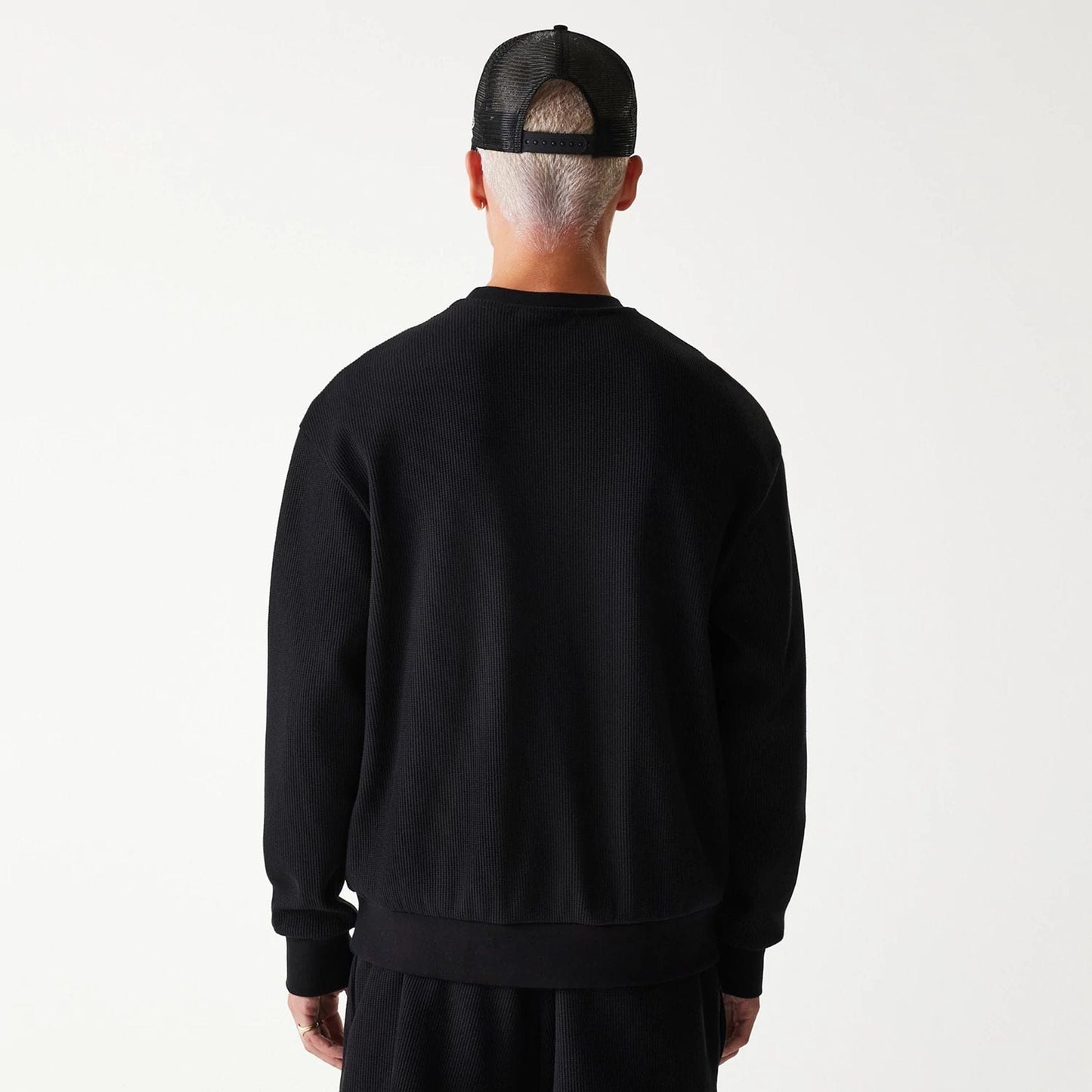 The Male model is wearing New Era Waffle Black Oversized Crew Neck Sweater 2