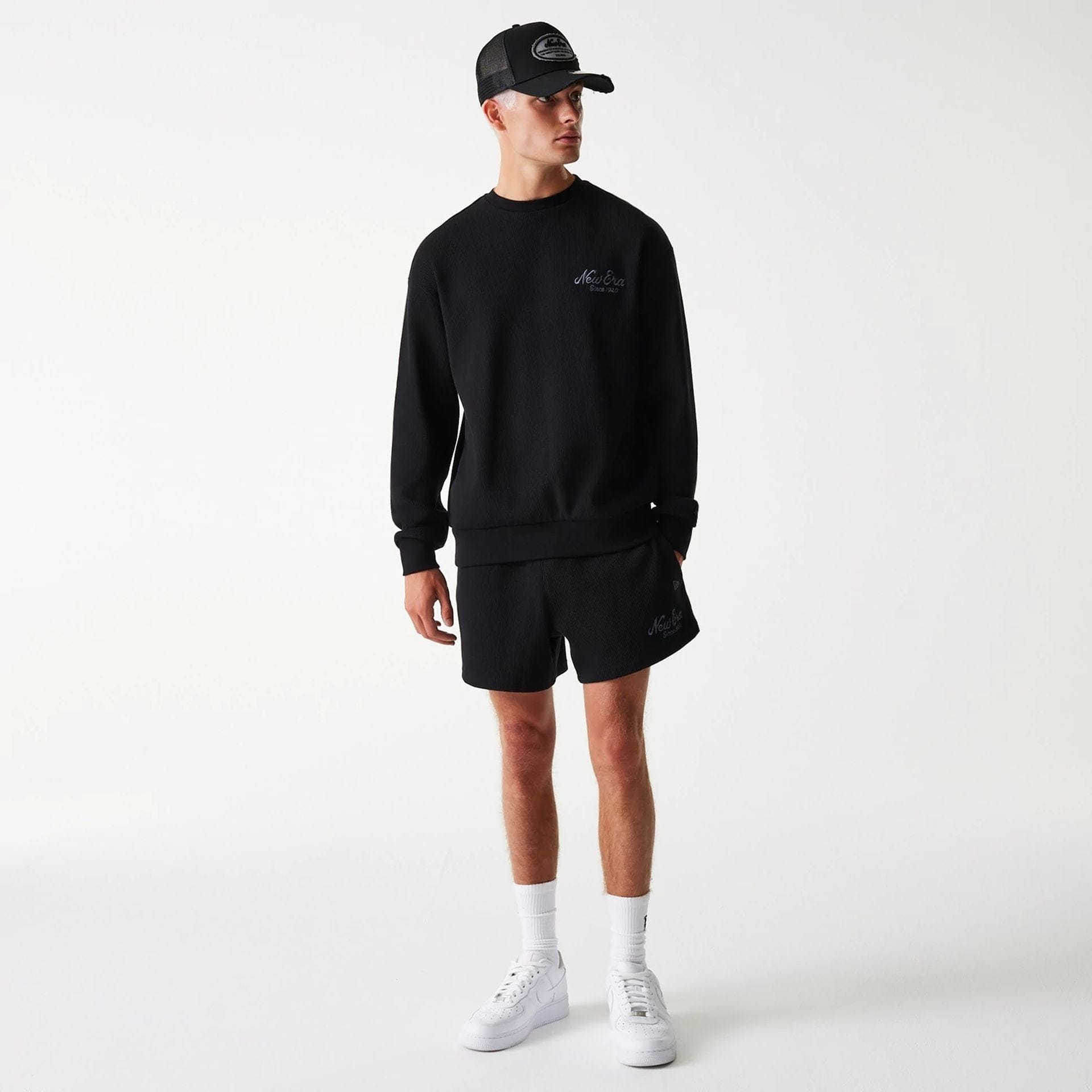 The Male model is wearing New Era Waffle Black Oversized Crew Neck Sweater 7