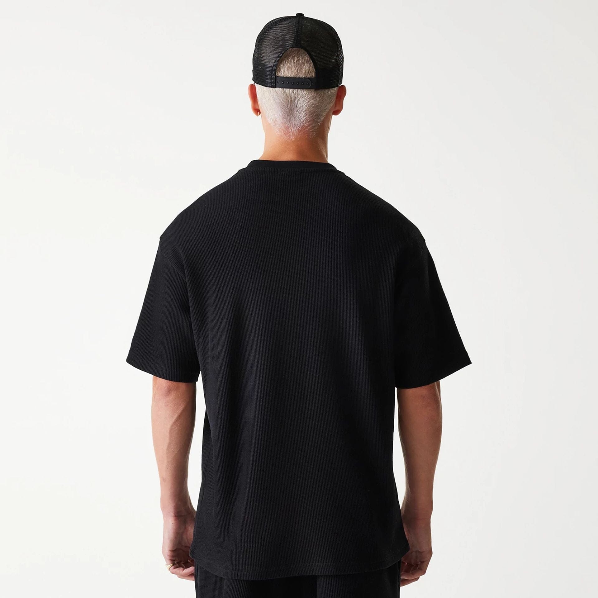 The Male model is wearing New Era Waffle Black Oversized T-Shirt 2
