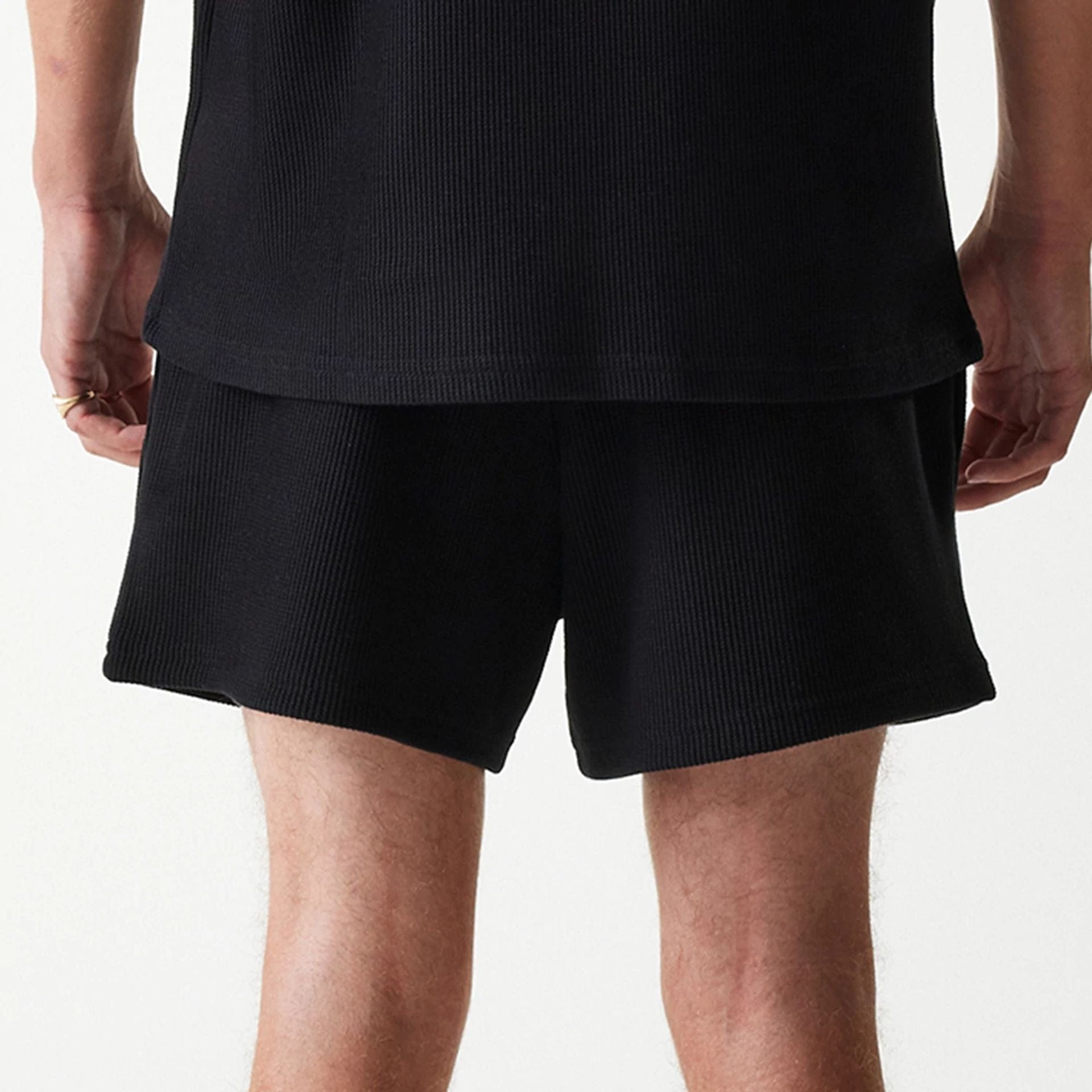 The Male model is wearing New Era Waffle Black Shorts 5