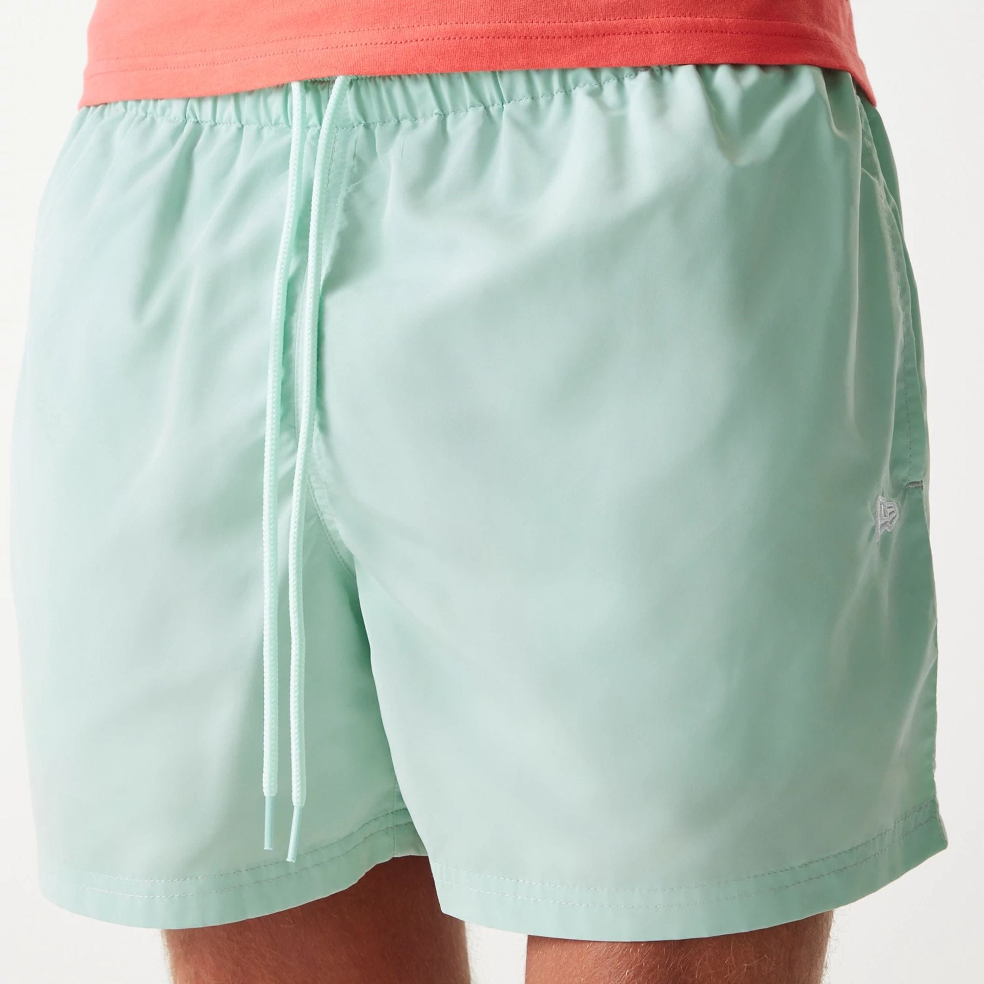 The Male model is wearing New Era Pastel Green Swim Shorts 5
